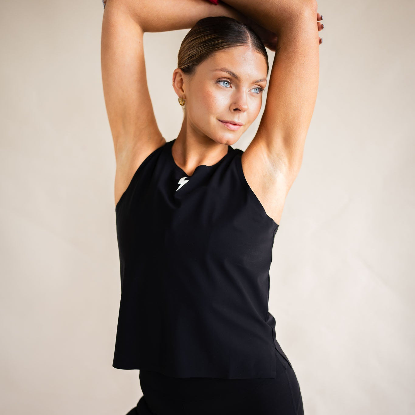 Cyclist in LUCA Meander vest in black, arms raised showing relaxed fit