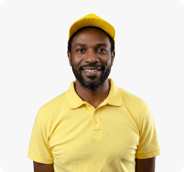 Portrait of Logistics Supervisor Stark Sandy smiling, dressed in a corporate yellow polo and matching hat.