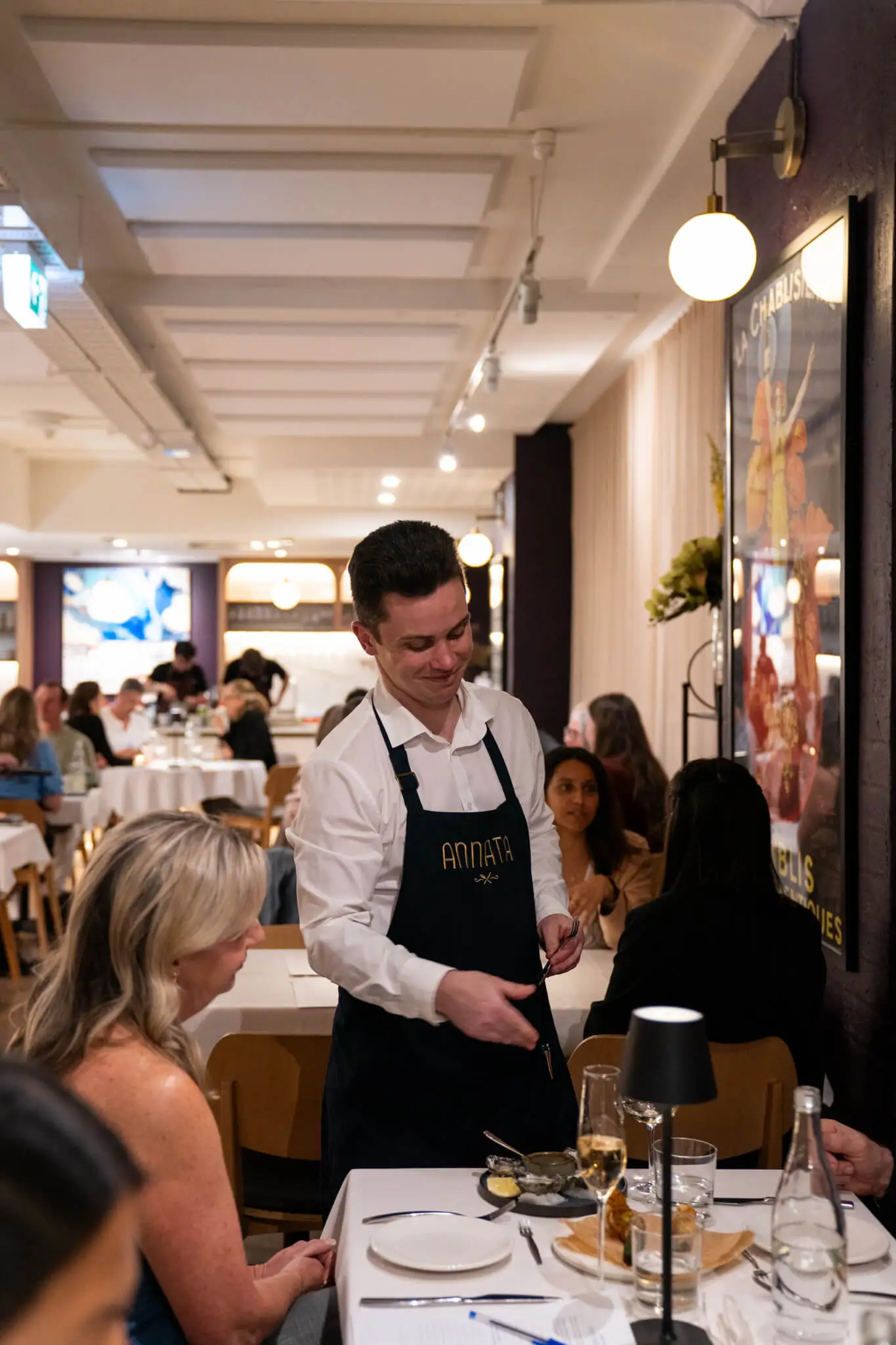 Blake Gibson, Restaurant Manager, serving guests at ANNATA
