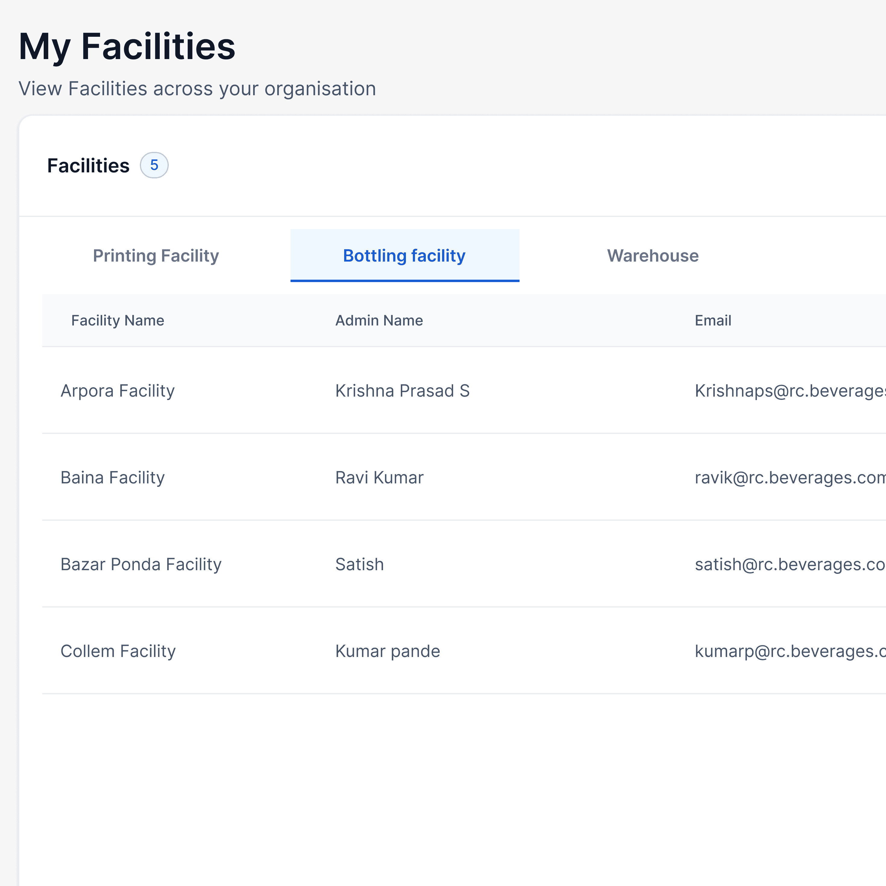 Woman in red outfit poses by a red telephone booth.