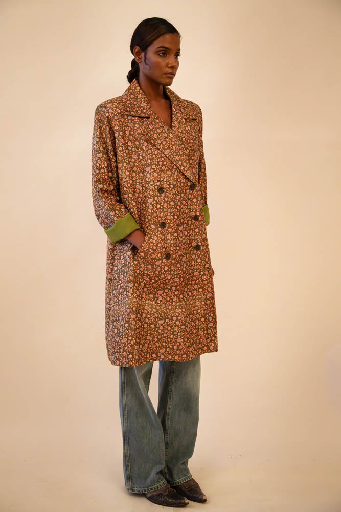 Ved is our one-of-a-kind paisley olive green silk trench coat, handcrafted by skilled artisans in-house using a vintage silk sari