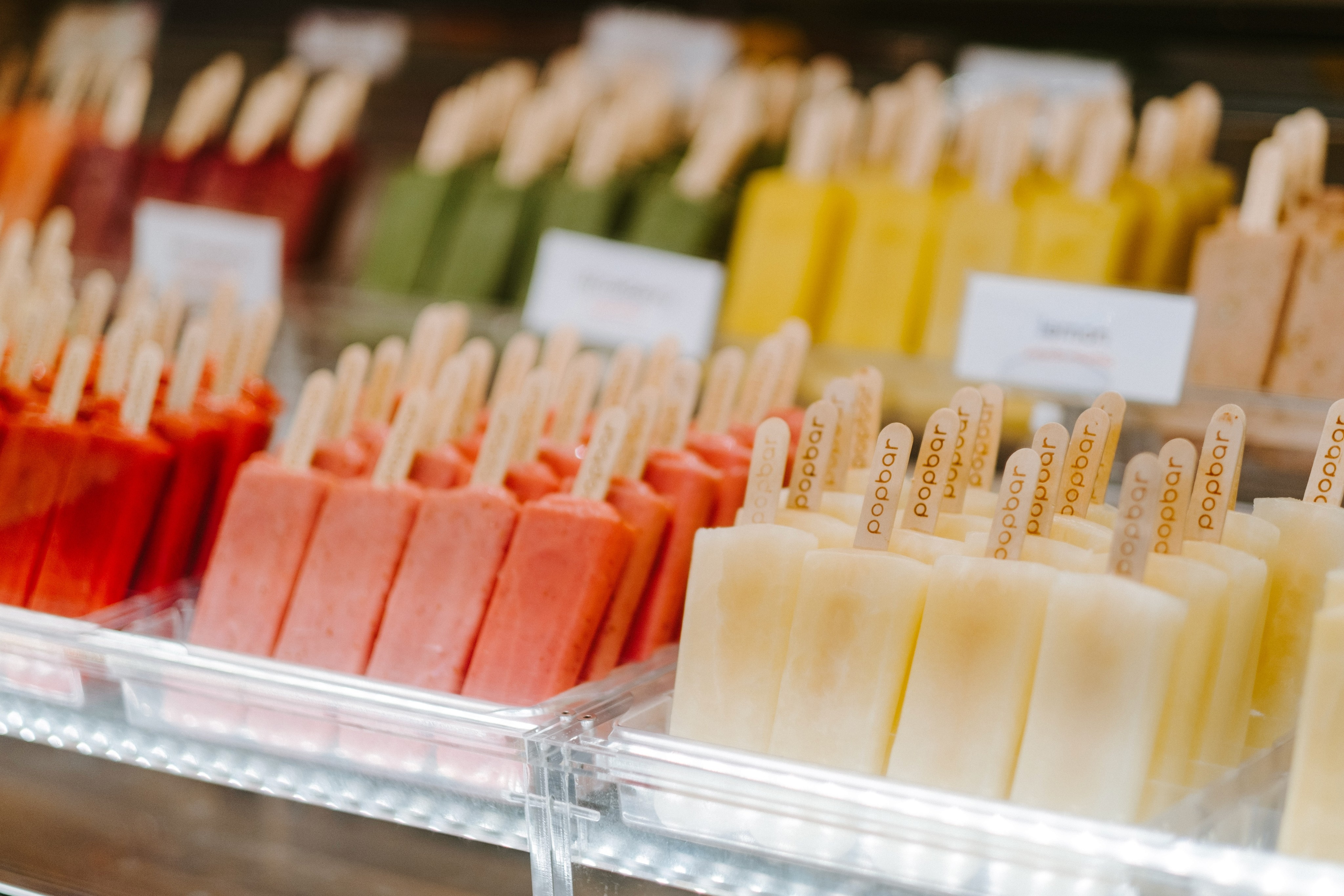 Multi-popsicle display with detail notecards blurred in the background.