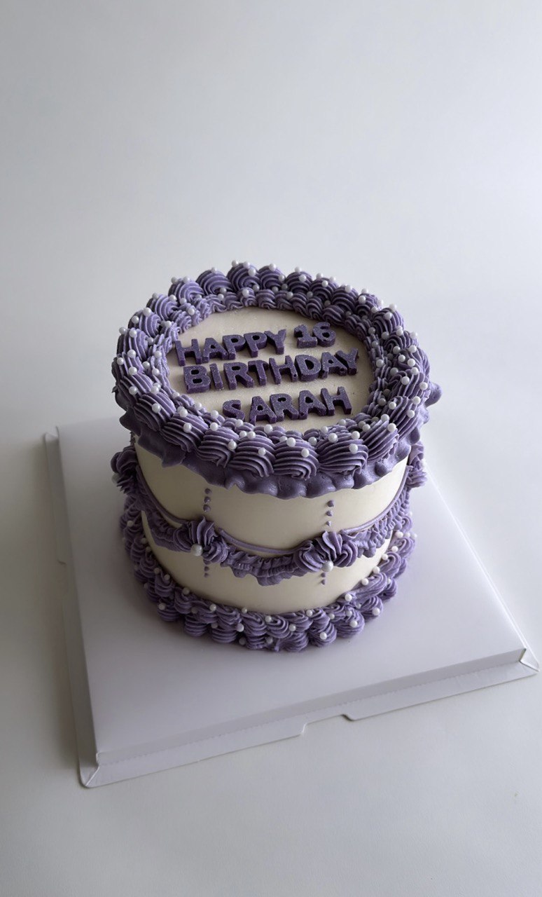 Birthday cake in violet and white colors, crisp lines