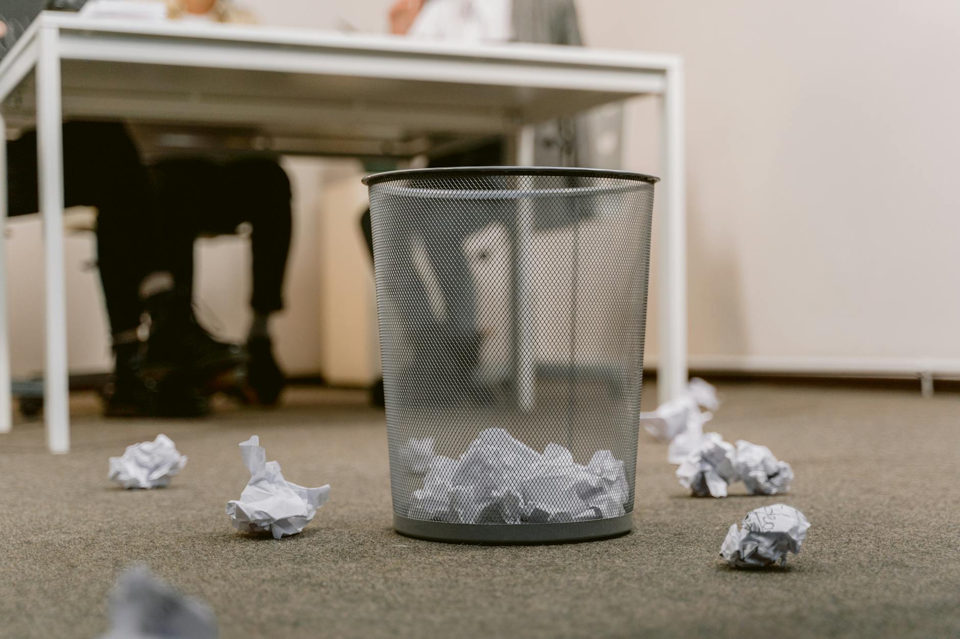 A frustrated student looking at a messy pile of disorganized papers and open textbooks.