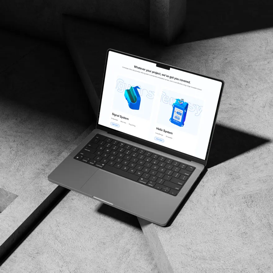 Open laptop on concrete surface displaying Converge product system options for Signal and Helix sensors.