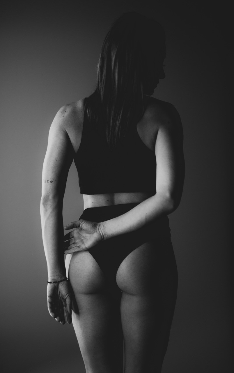 a woman in a black bra top and panties