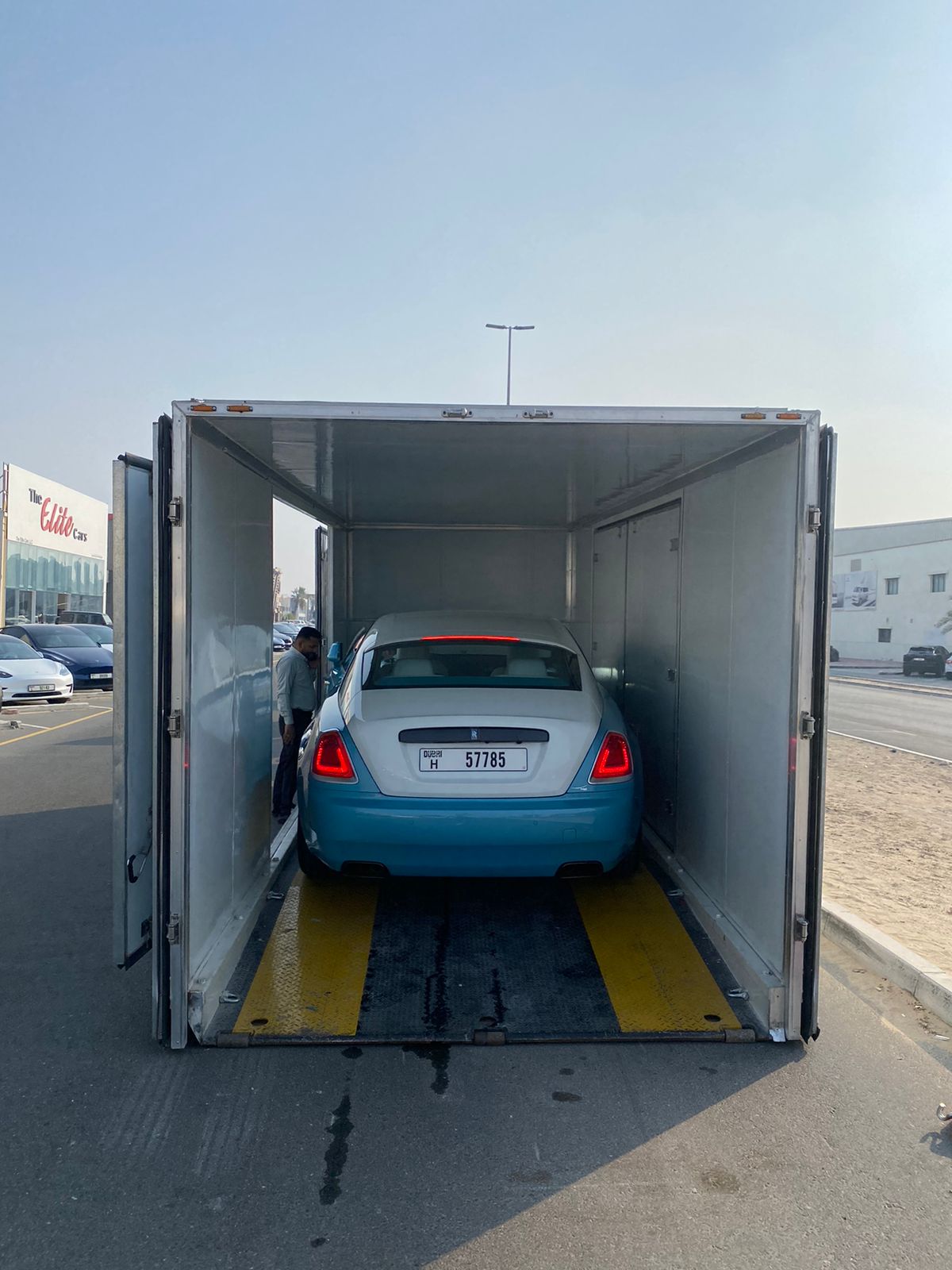 Extra Space car shipping of a Rolls-Royce Wraith. It is placed in an enclosed haulier outside a car dealership to prepare for transport.