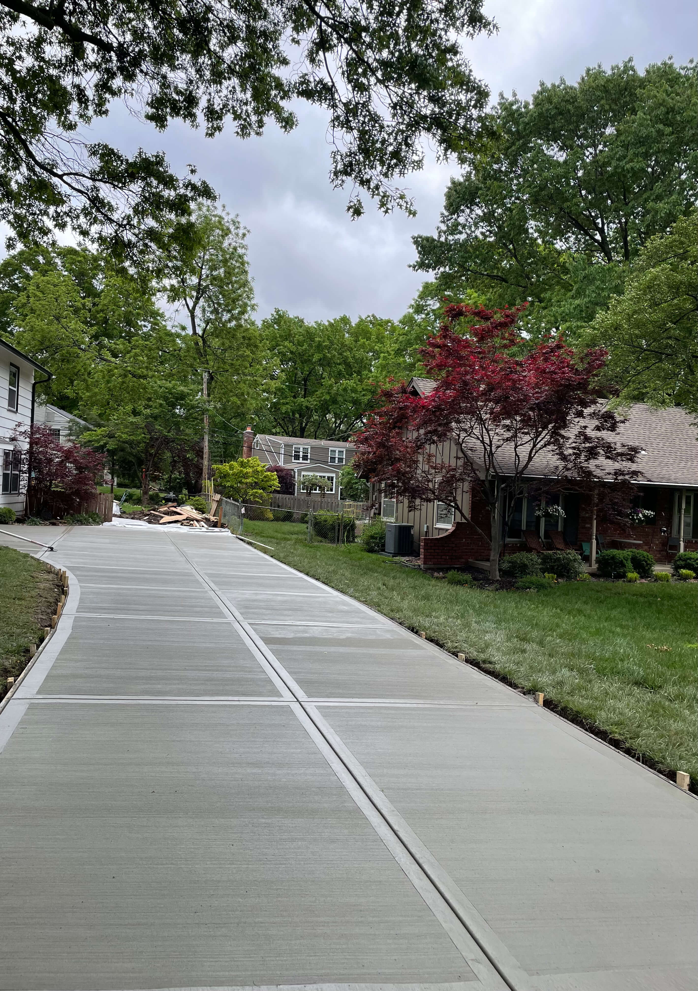 An image of a newly poured brushed concrete driveway.