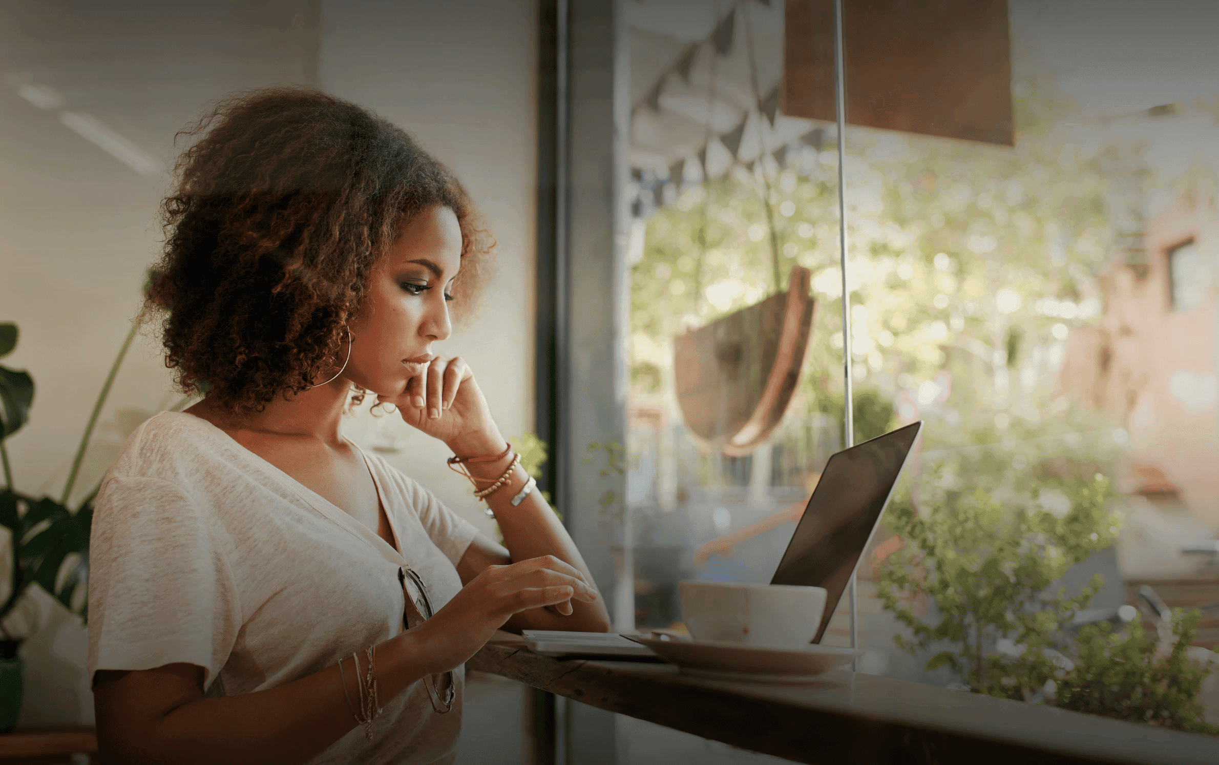 Young black woman working at her laptop