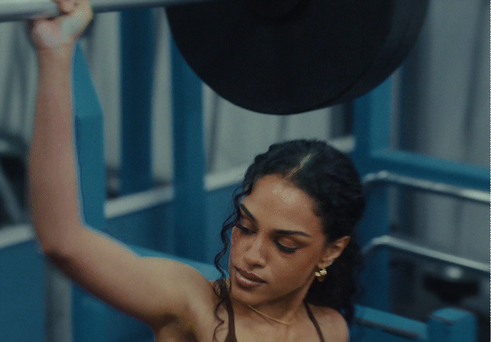 Silhouetted crowd observes pyramid through large windows.