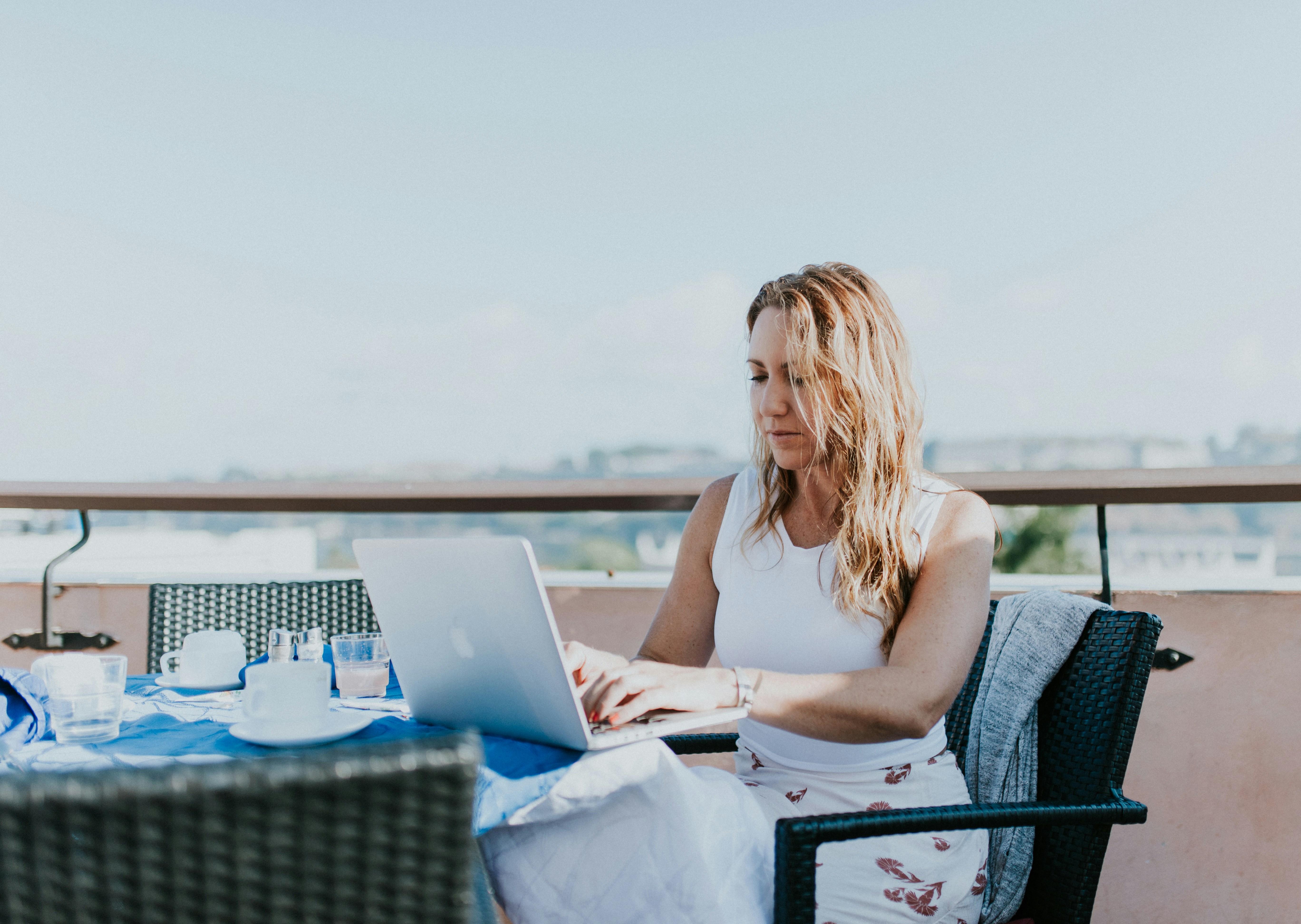 woman in roof top working with Rytr alternatives