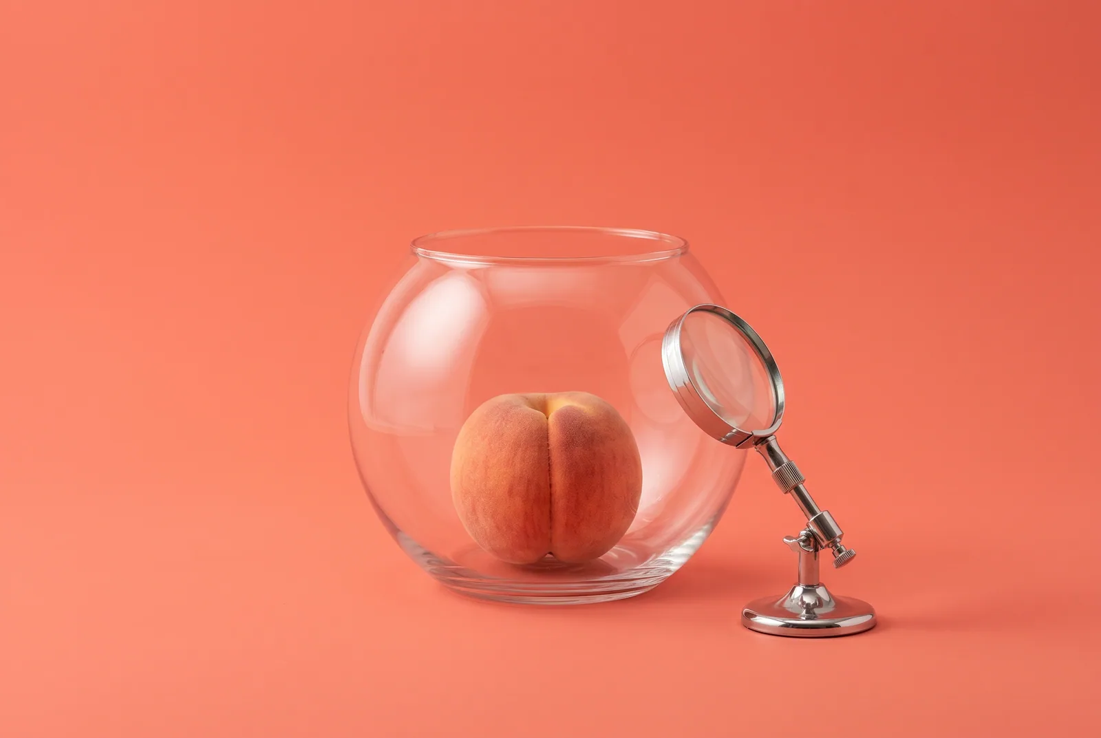 A peach inside an empty glass fishbowl watched by a chrome lens, the privacy risks of AI porn addiction and AI girlfriends