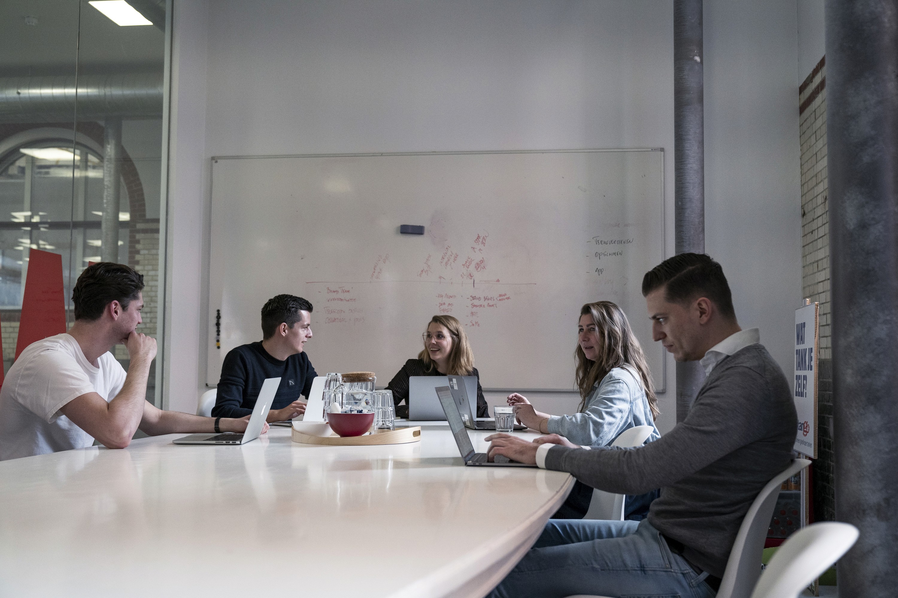 people in a meeting room discussing facts