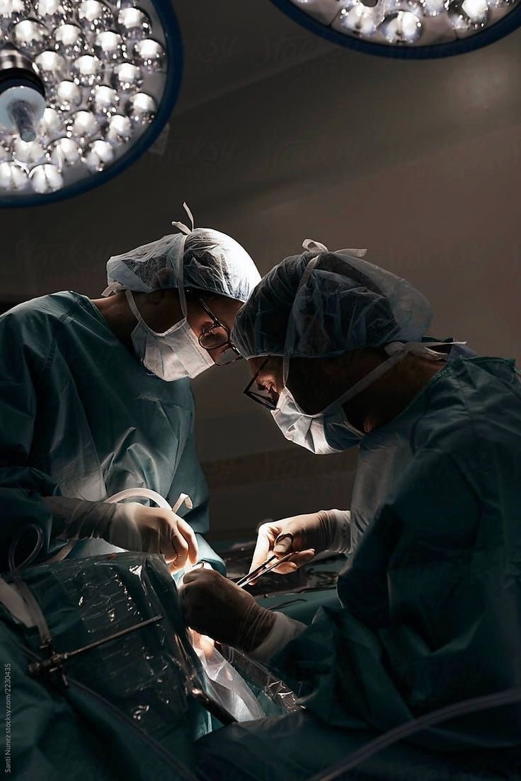 Surgeons operating in an operating theatre