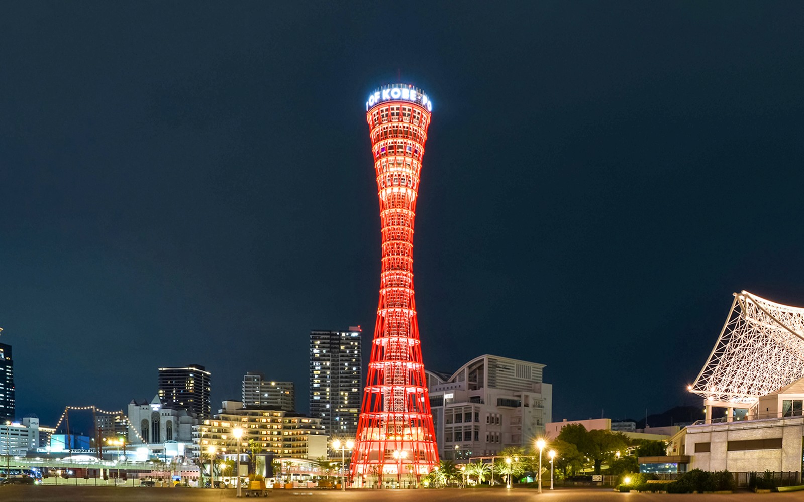 Kobe Port Tower illuminated at night in Kobe, Japan.