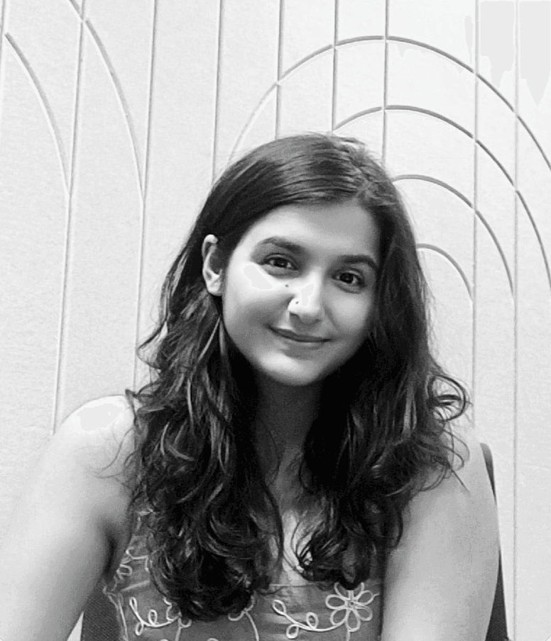 Close-up of a dark green leaf showing its textured surface and central vein against a muted background.