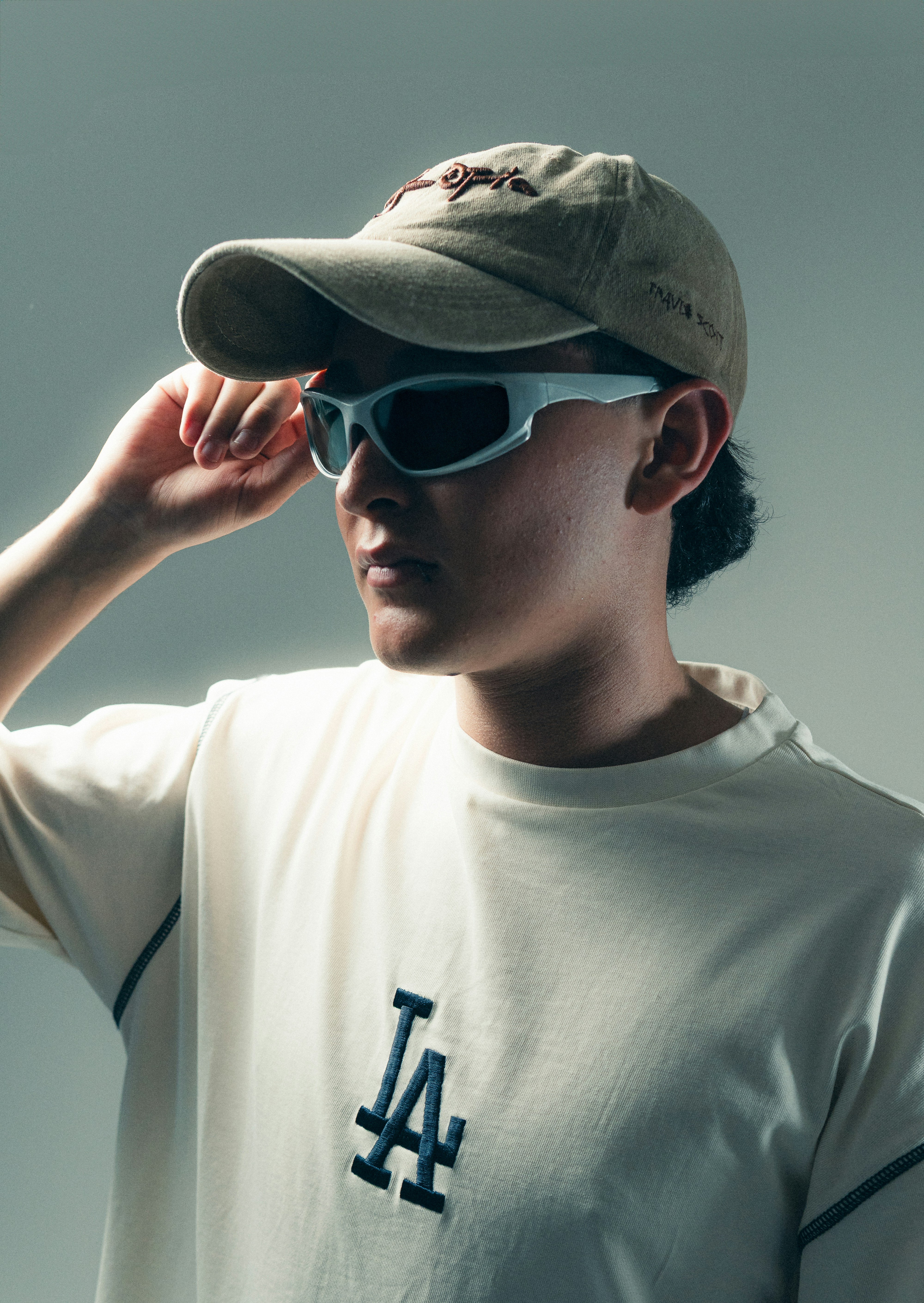 A person wears glasses and a hat.