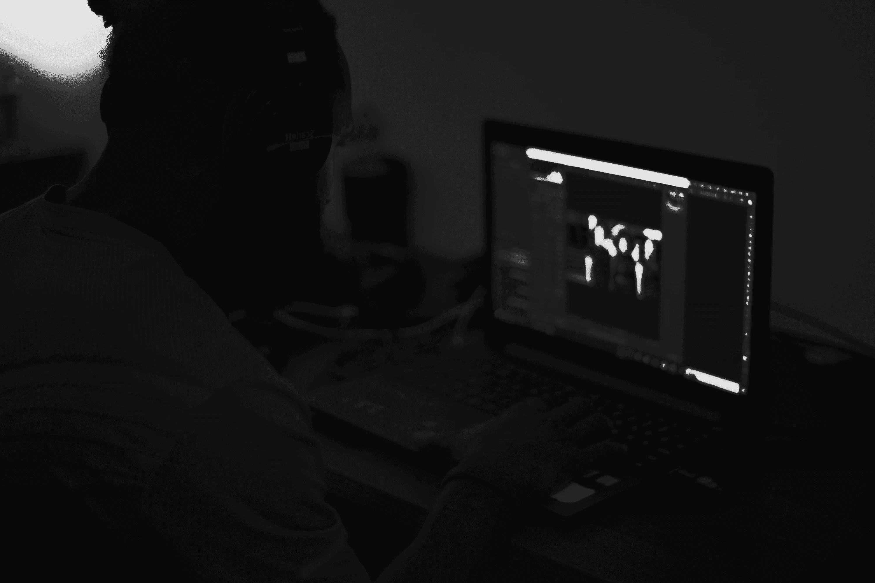 A man sitting in front of a laptop computer