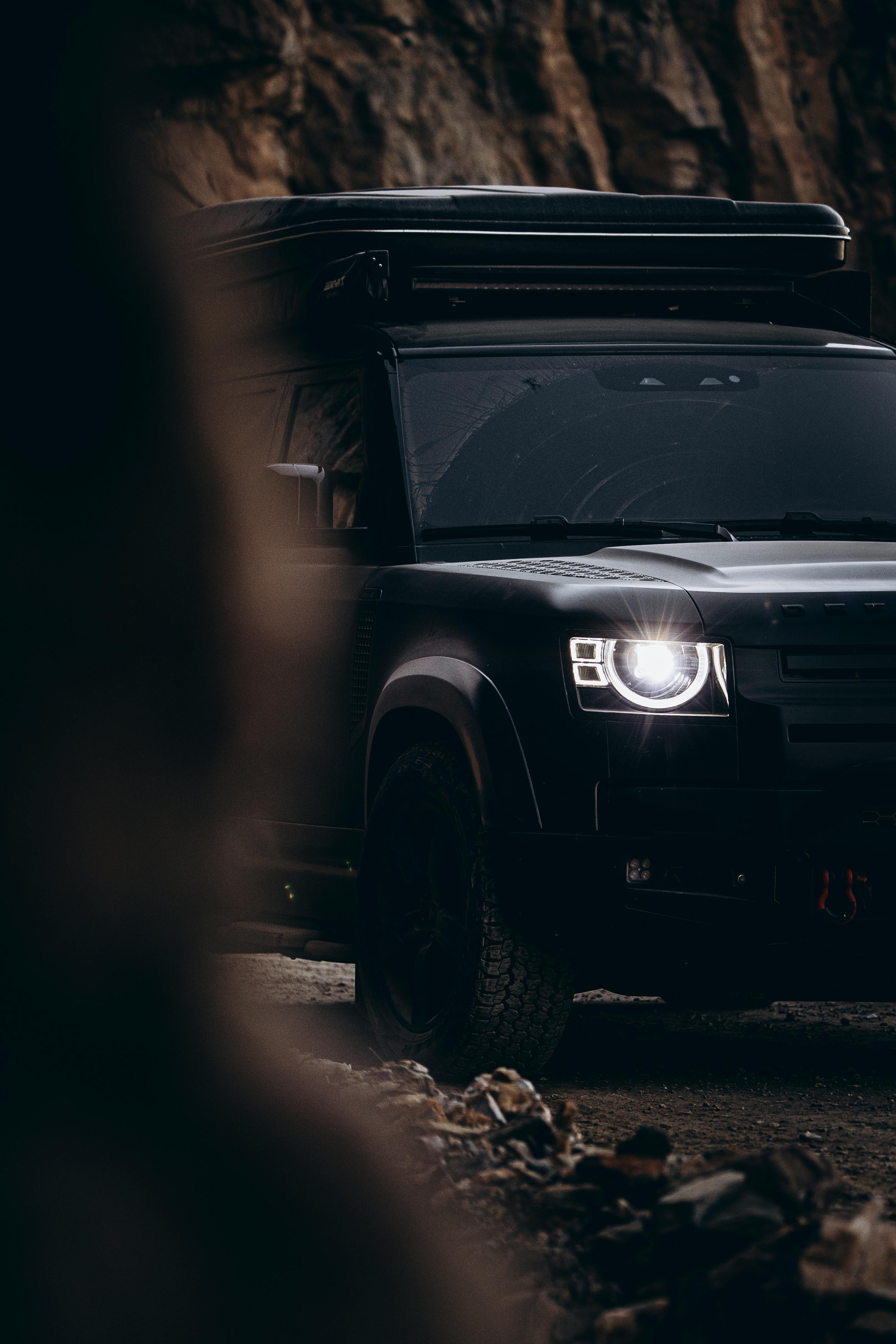car parked with a building and trees in the background