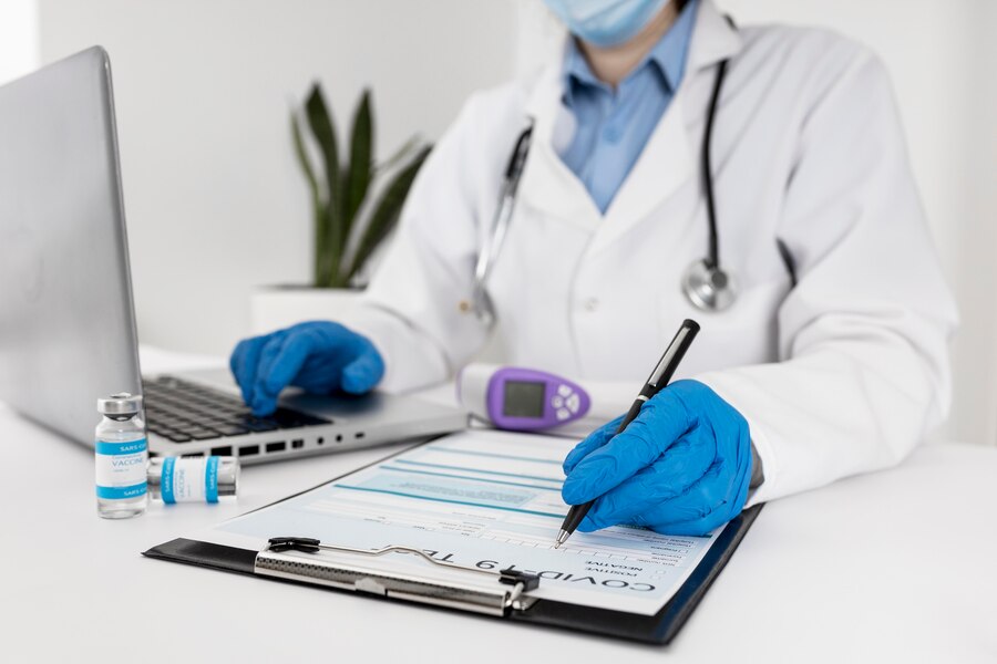 A doctor linking the reports of a patient along with medication.