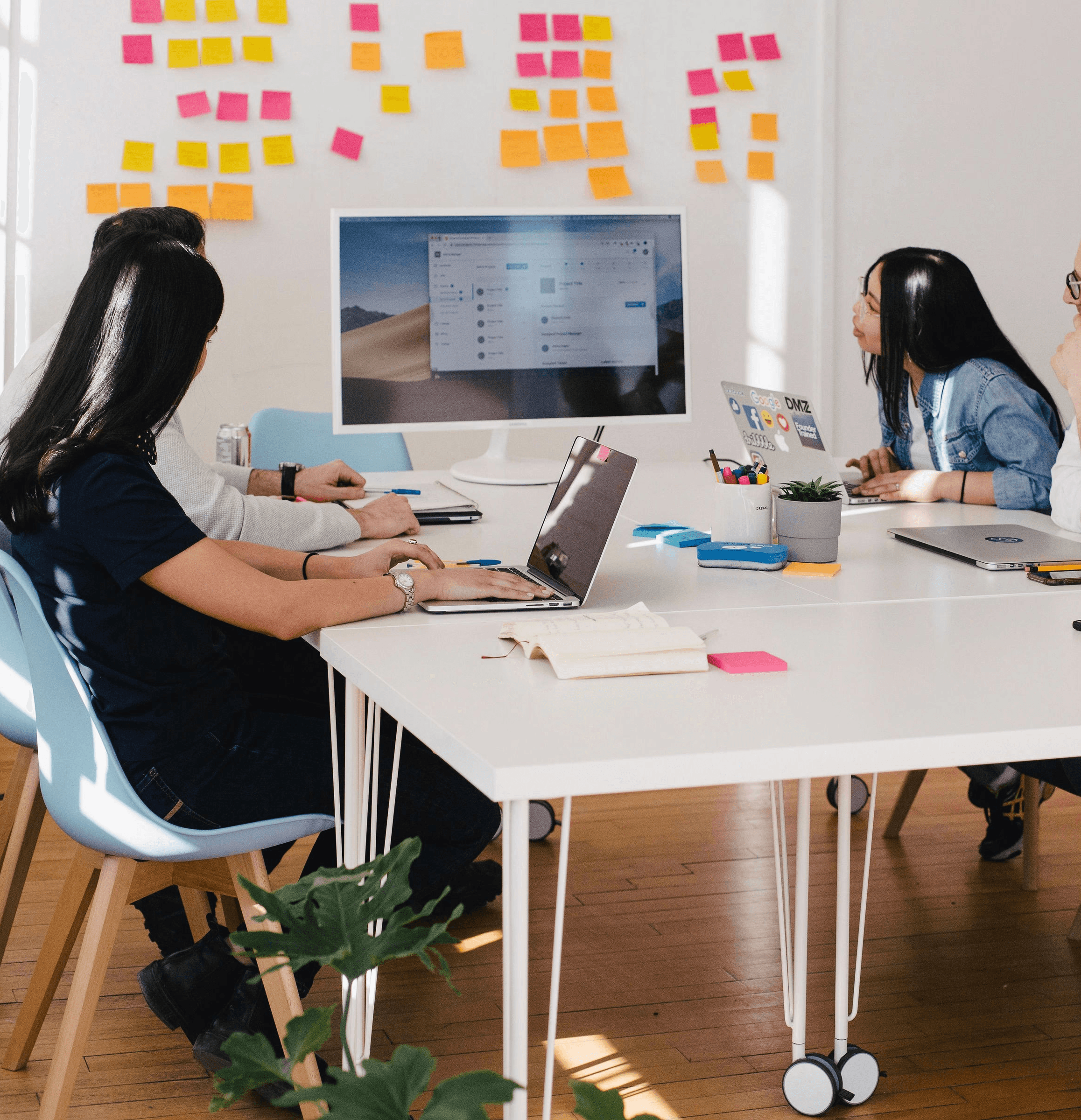five person by table watching turned on white iMac