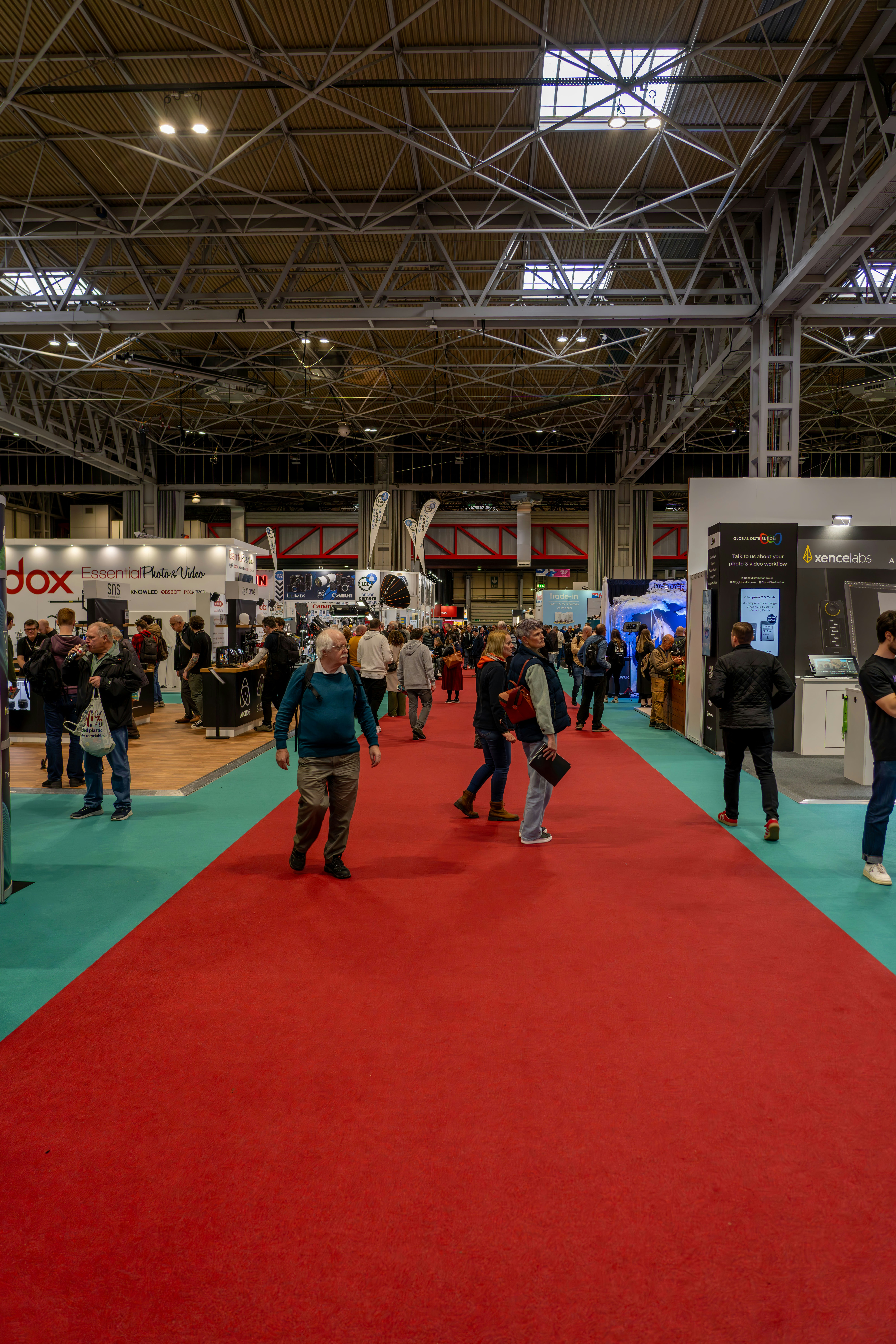 a group of people standing around a red carpet
