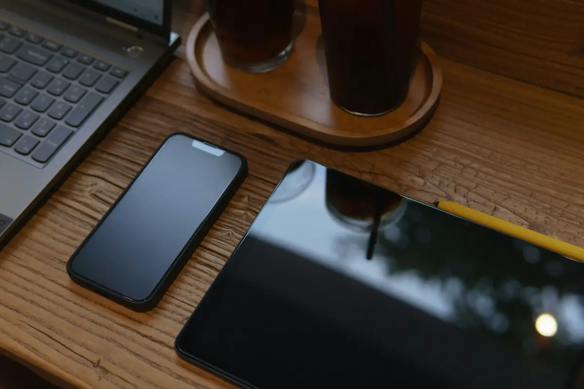smartphone, tablet, and laptop on table