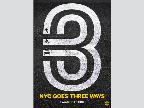 The image shows a stylized road design on a dark asphalt surface. The design features a large white number "3" with curved lines around it, symbolizing a three-way intersection. Below the design, the text "NYC GOES THREE WAYS" is displayed in yellow, followed by "3WAYSTREET.ORG" in smaller white text. The number "3" is stylized with a bicycle symbol inside it, and a car symbol is included to the left. The design is on a dark background with white text and symbols.