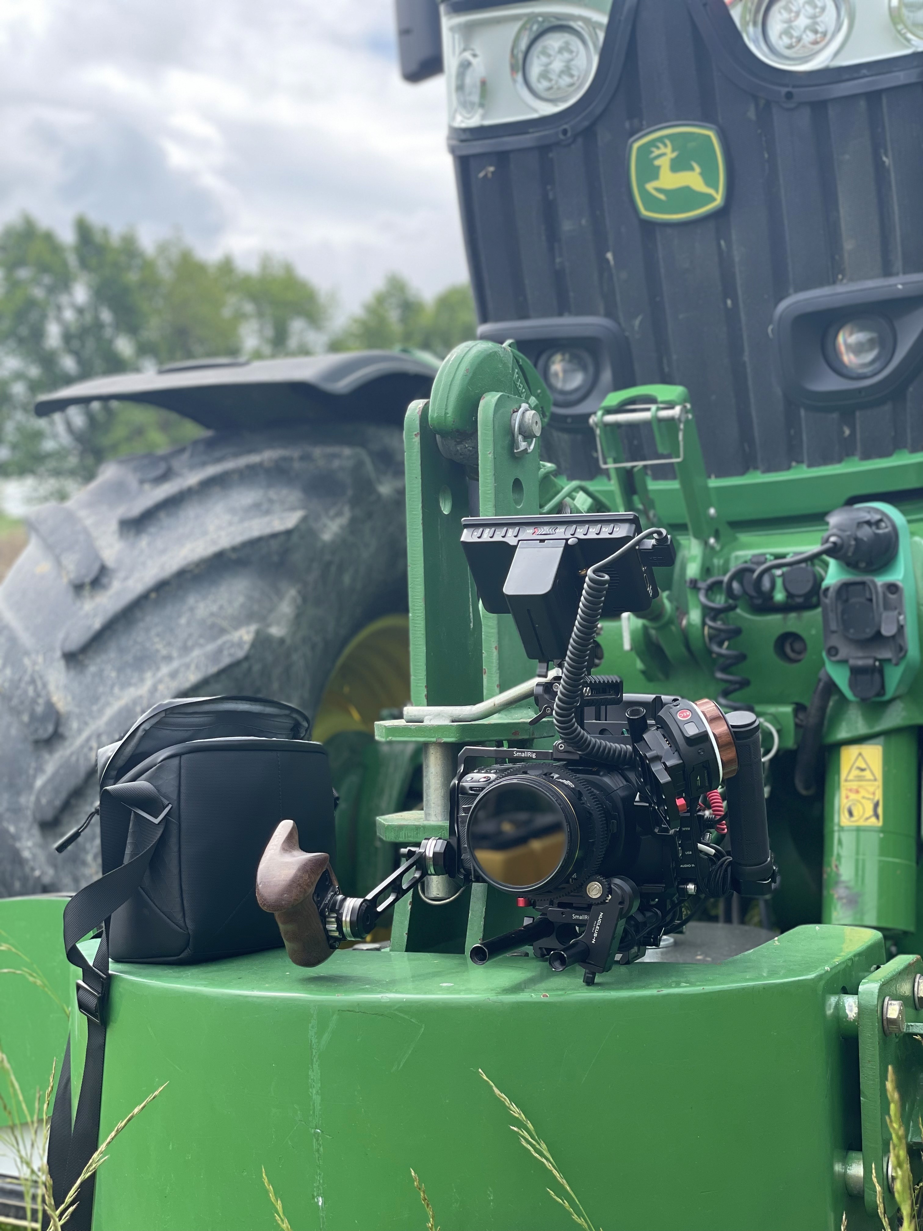 Black and white image of people working at a table with laptops, showing hands gesturing during discussion of digital content displayed on screens, with fabrica® logo in the corner.