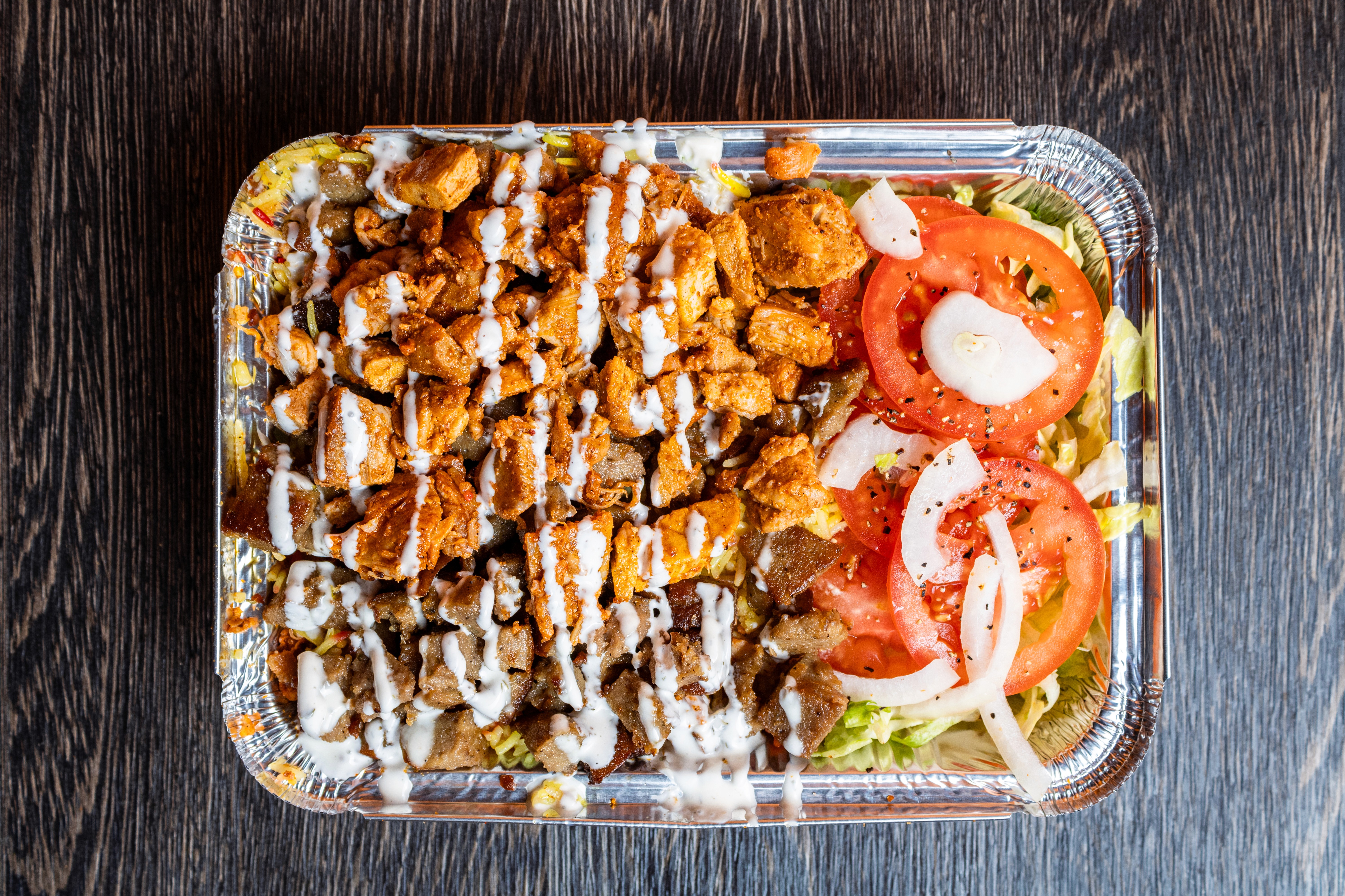 a glass of cocktail with a slime orange fruit