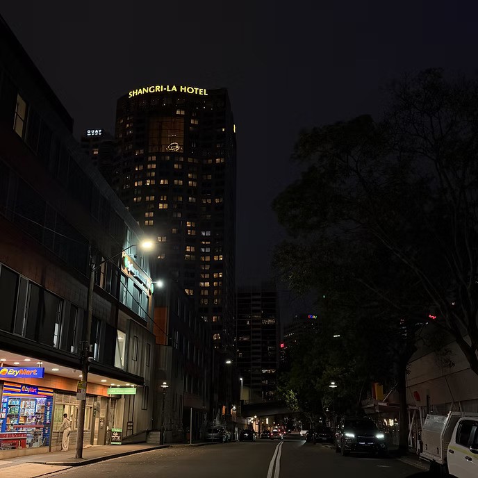 Night time street view in Sydney CBD with the Shangri-La Hotel illuminated in the background