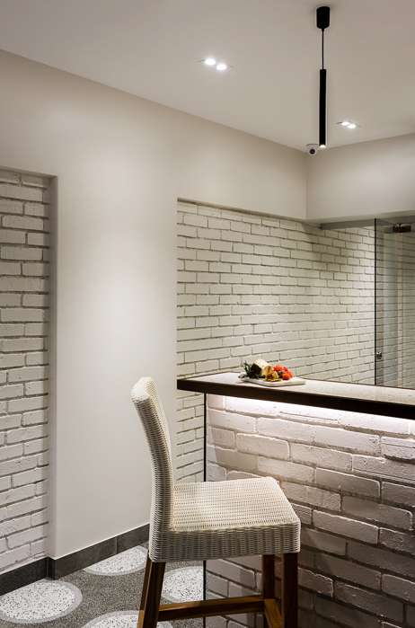 Nature-inspired preschool entrance with sculptural tree partitions and suspended green leaf ceiling panels.