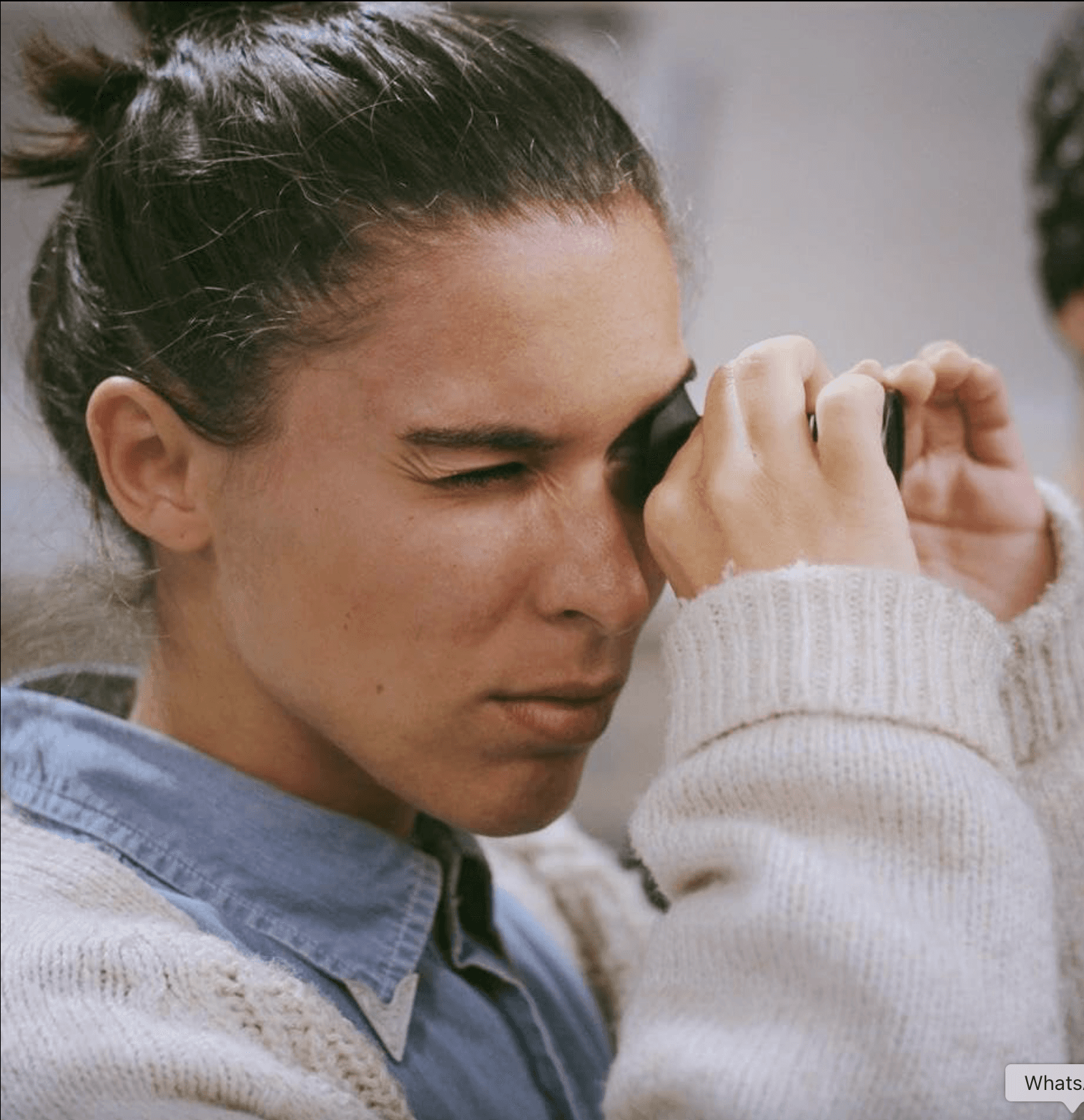 Person, holding a white rose behind his back with one arm on a light blue background