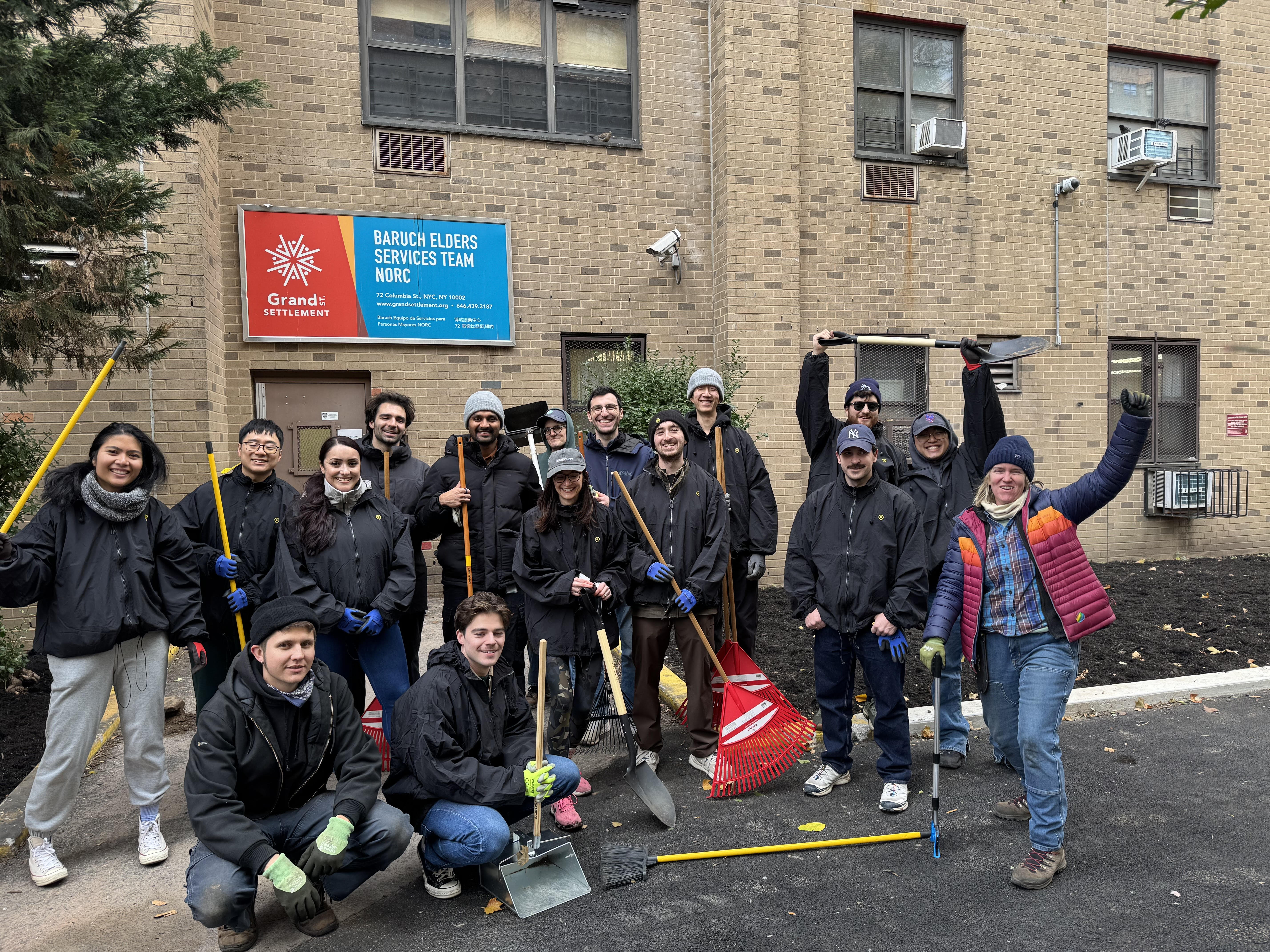 Volunteers pose with their shovels and rakes triumphantly.