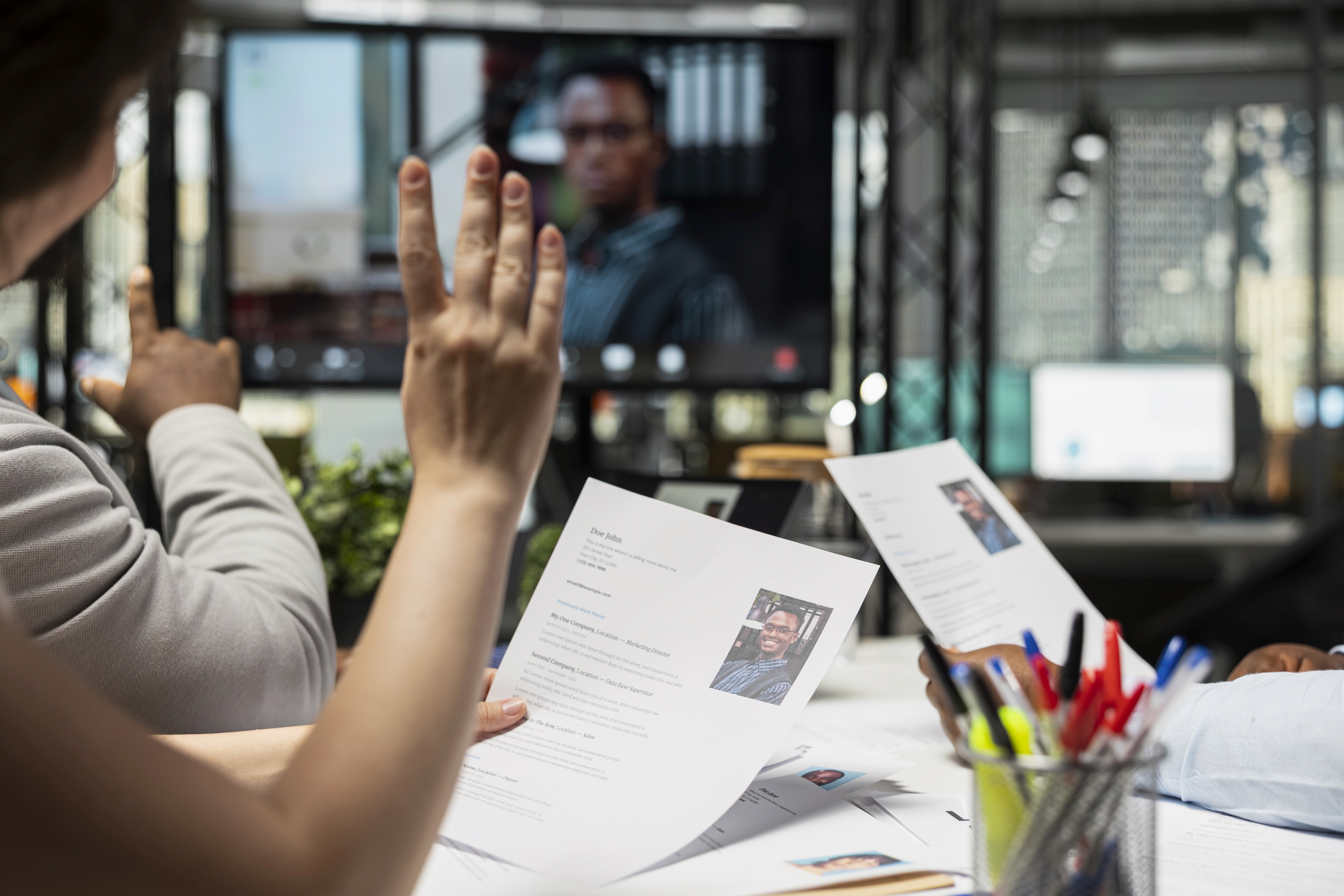 Close-up of a dark green leaf showing its textured surface and central vein against a muted background.