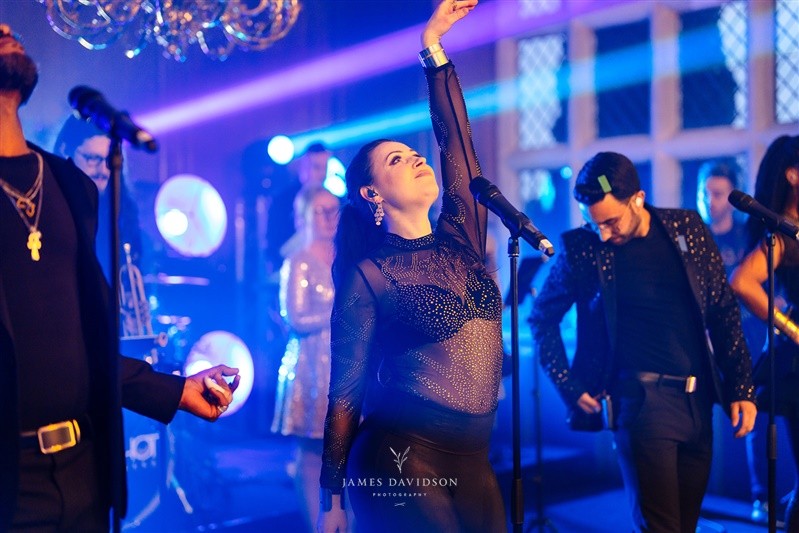 A singer raising her arm during the band's performance