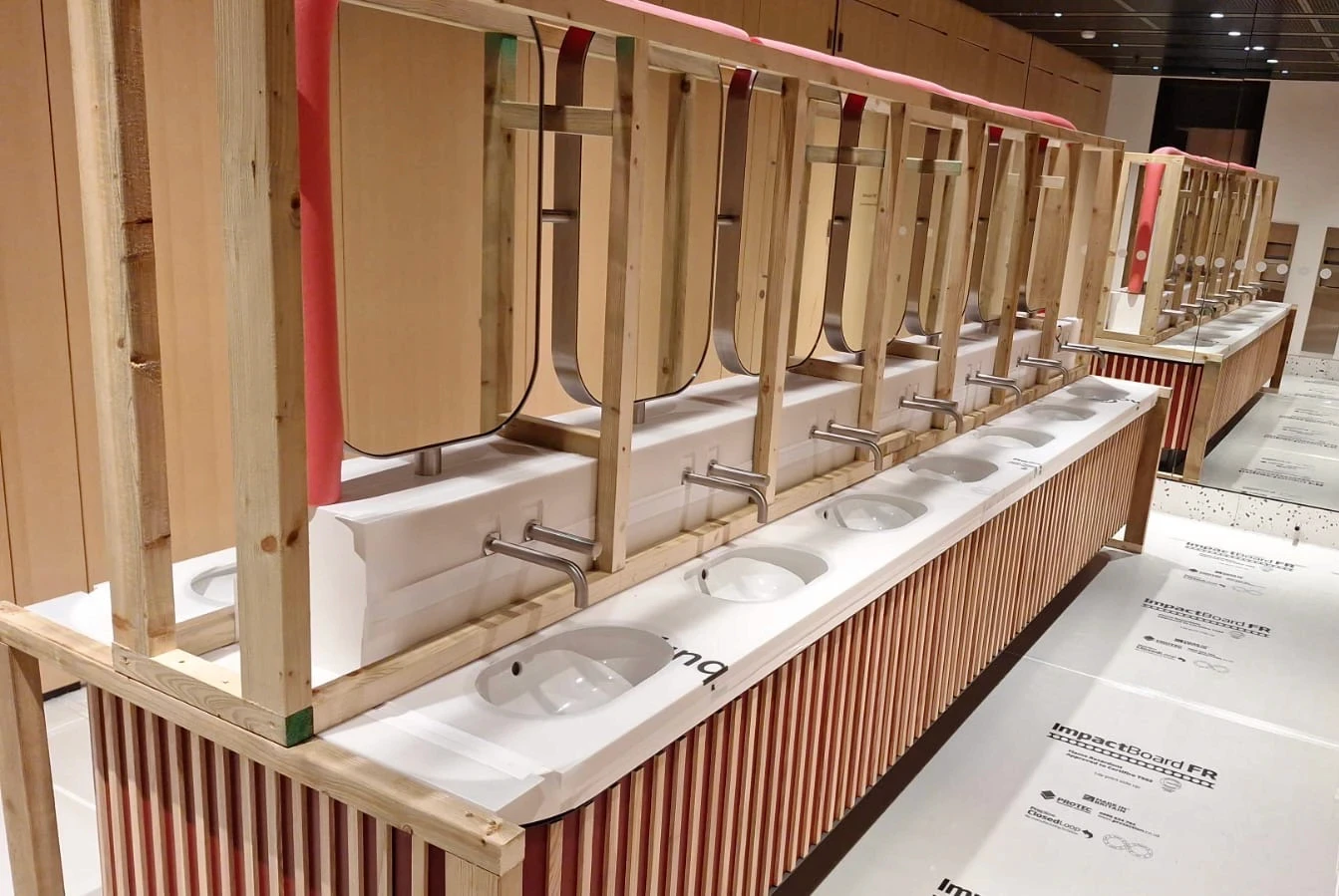 A digger inside a warehouse under construction