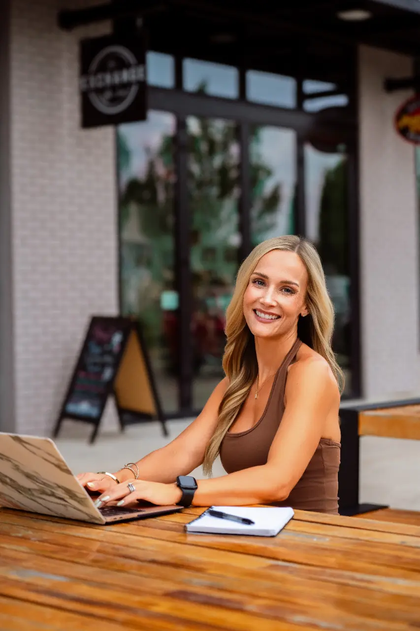 Woman working outdoors in a brown Aspire Athleisure set