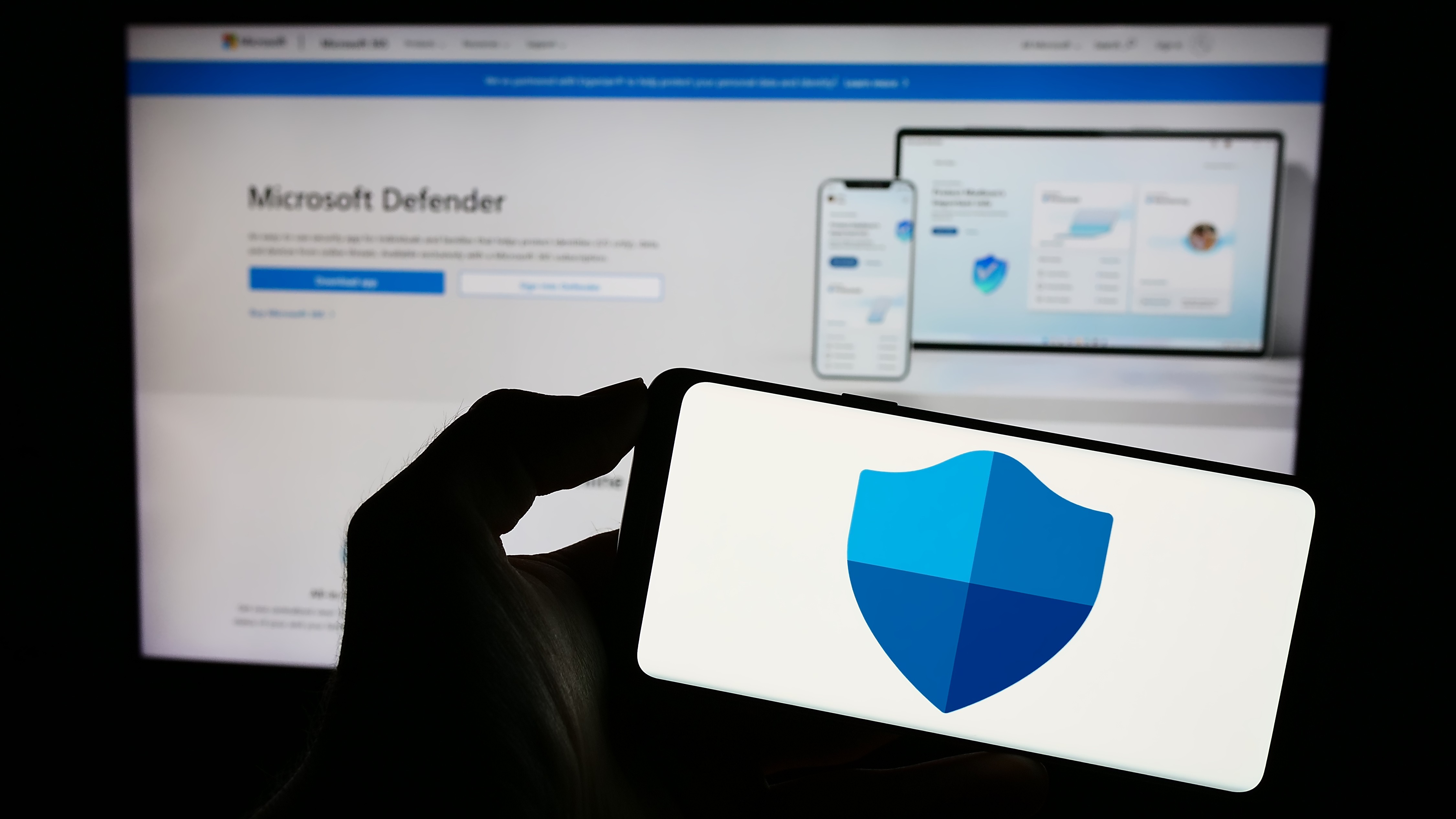 Person holding mobile phone with logo of security software