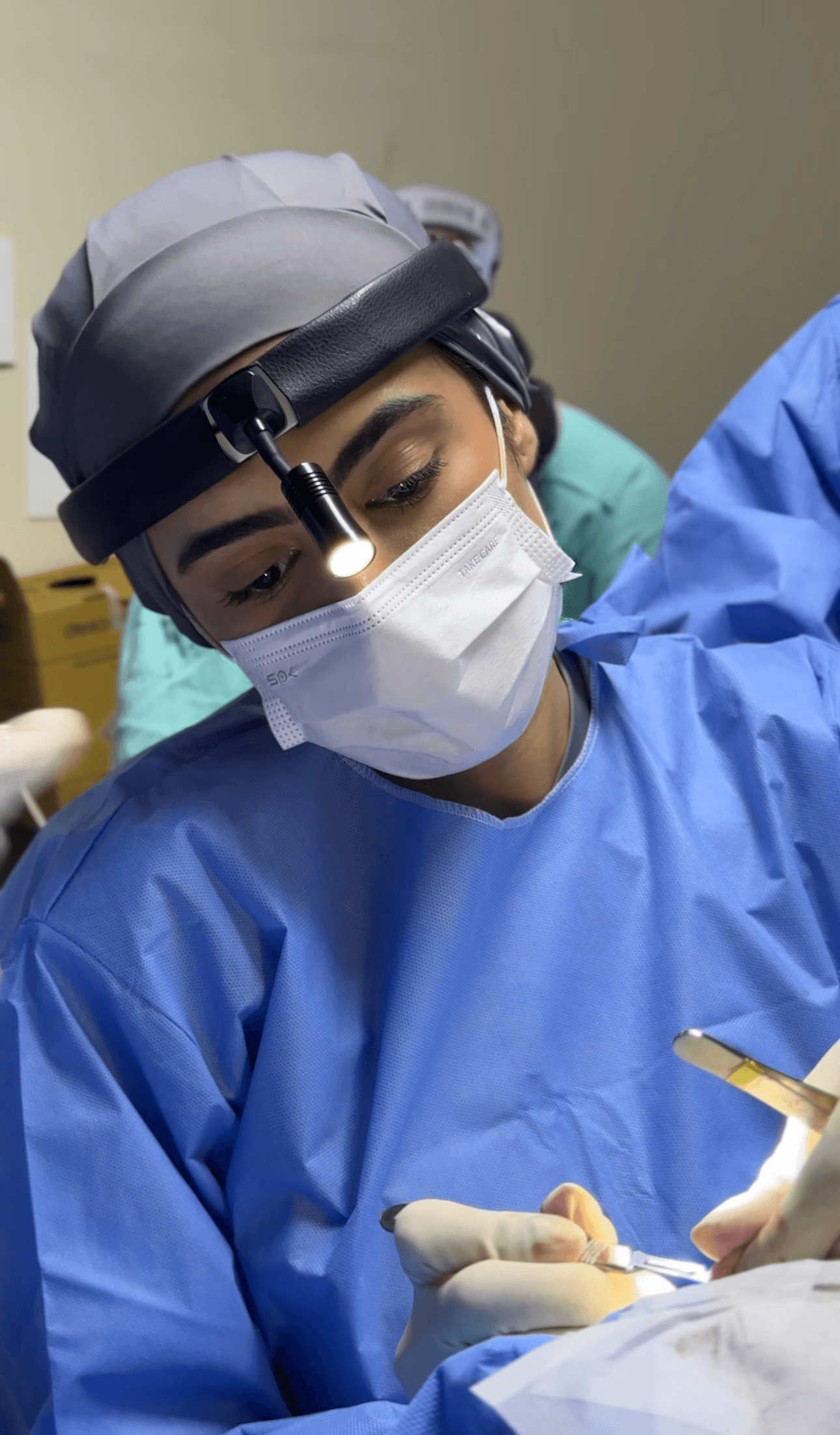 A woman receives a relaxing energy healing in a serene setting with soft lighting.