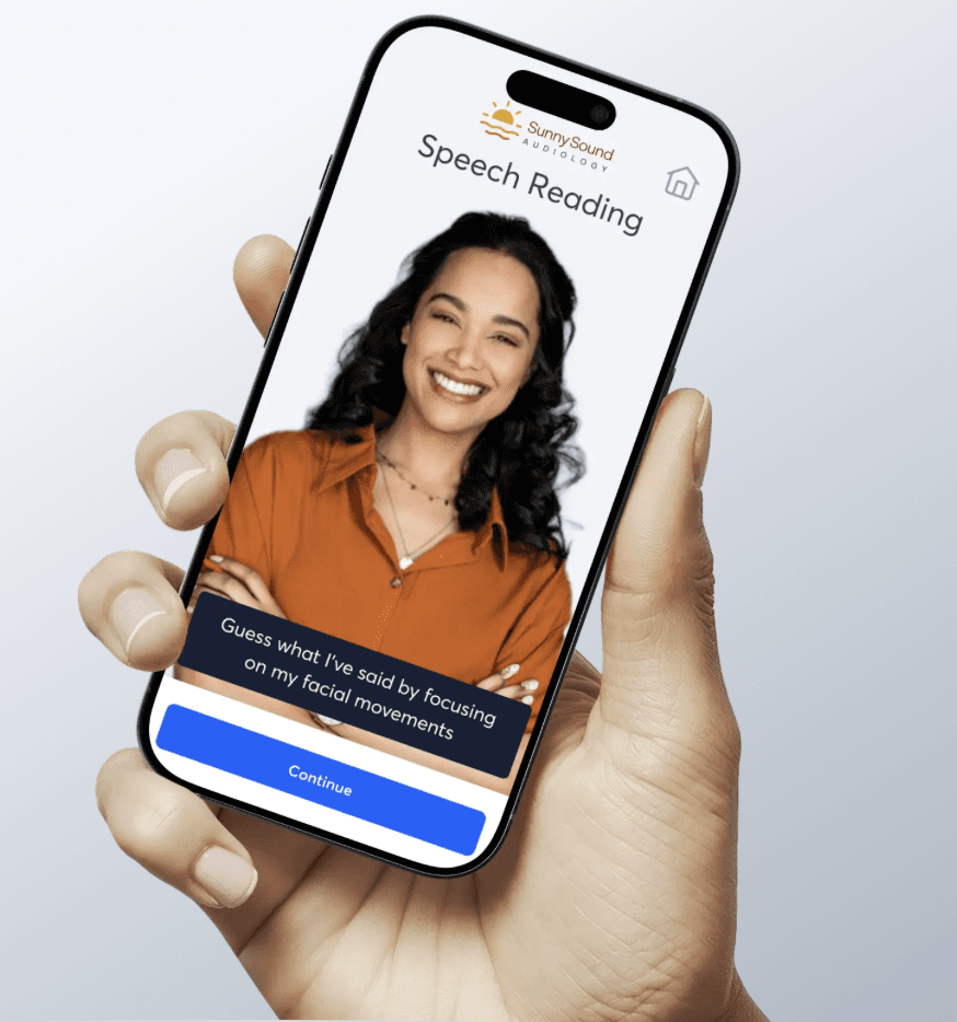 Four people, two men and two women, are gathered around a book, engaging in a friendly discussion.