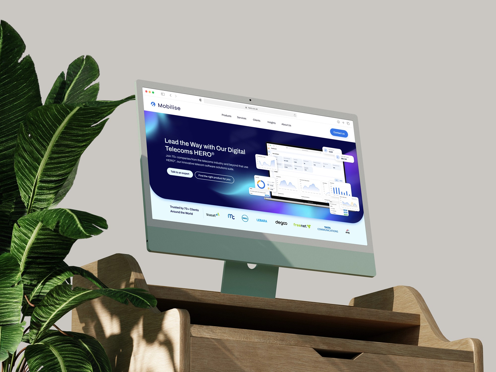 Desktop monitor showing the redesigned Mobilise website homepage with analytics dashboard illustration.