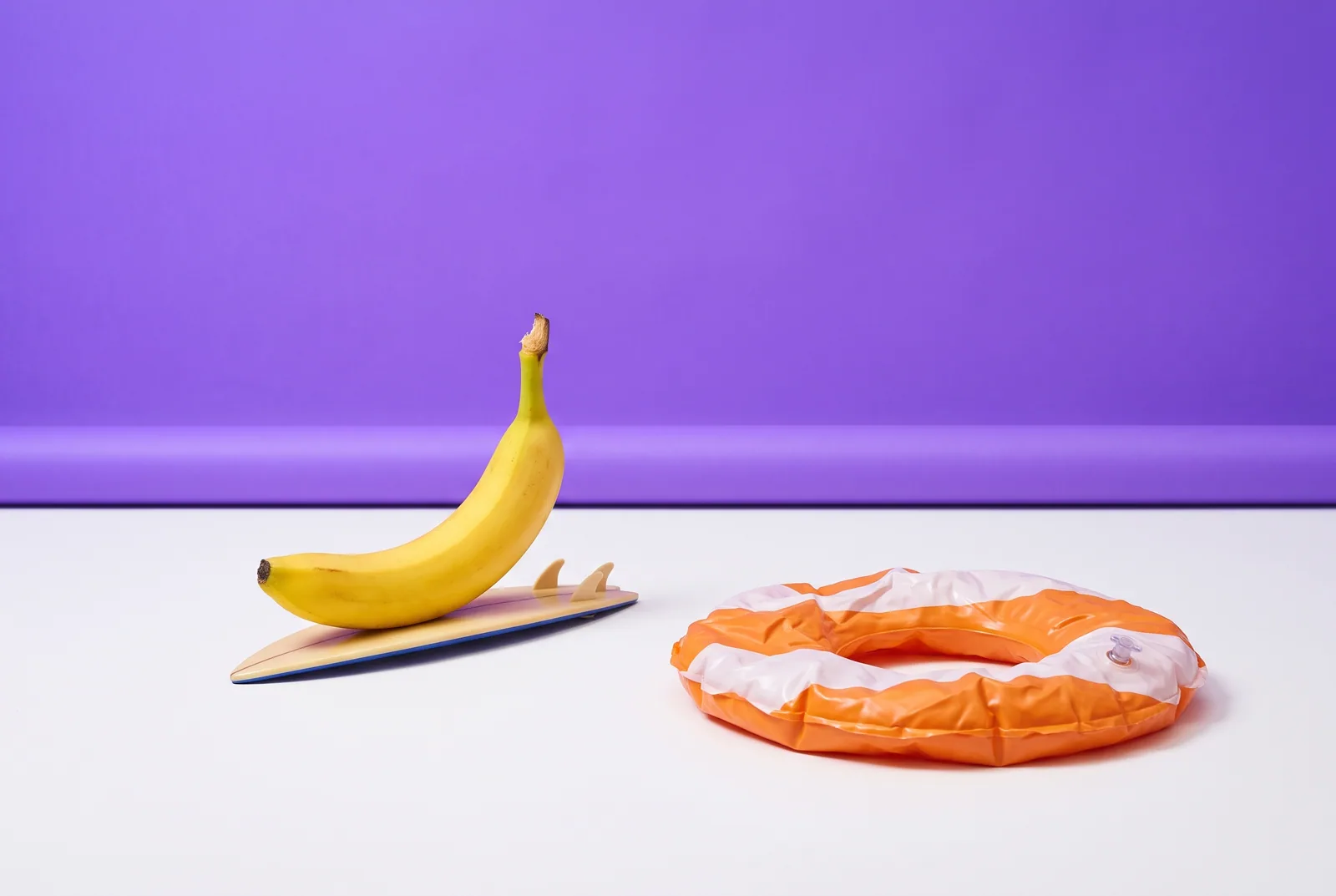 A banana on an upside-down surfboard on a dry floor, common urge surfing mistakes