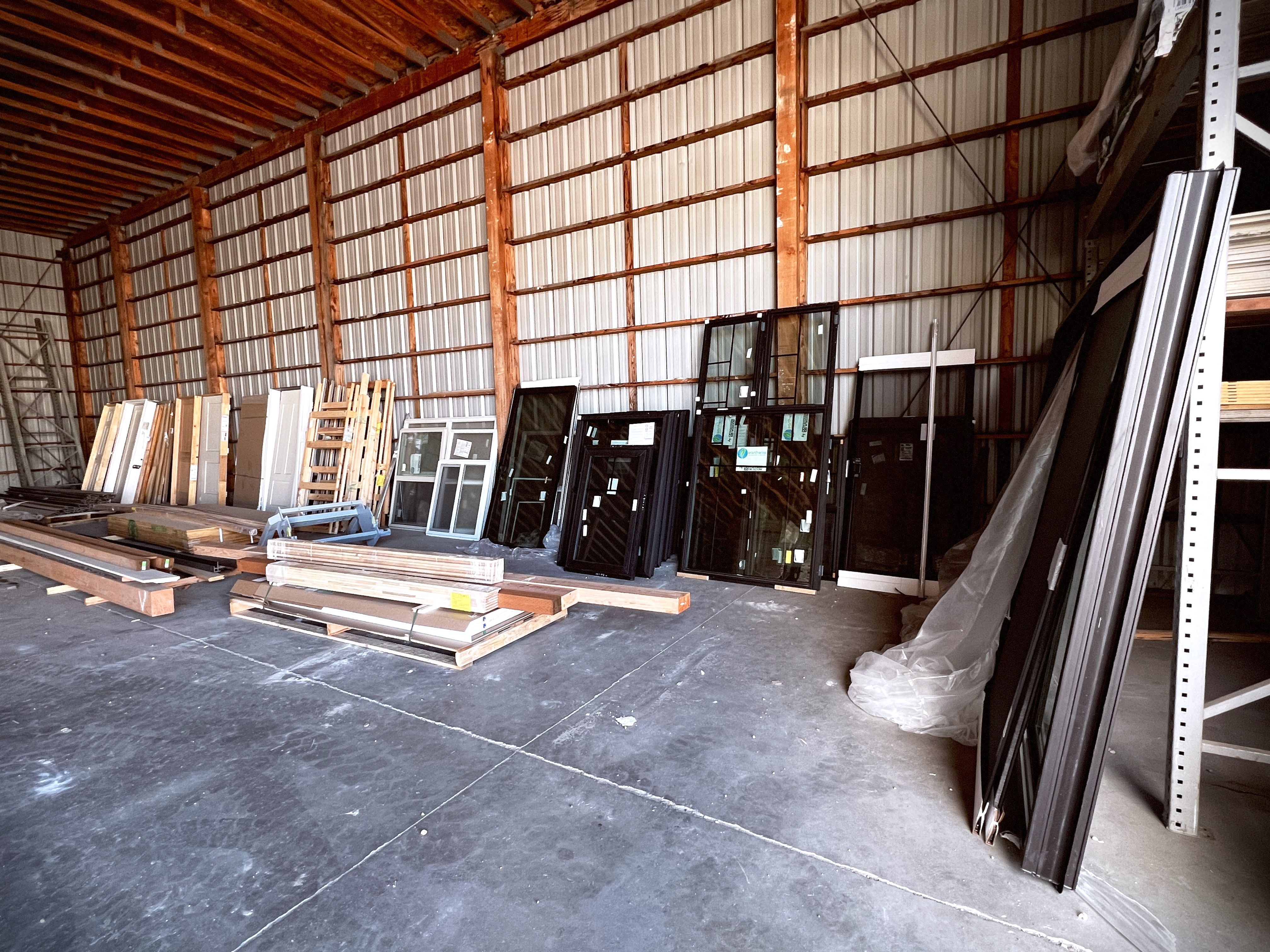 Inventory of Western Window Systems frames and assorted doors organized in Capital Lumber’s storage area.
