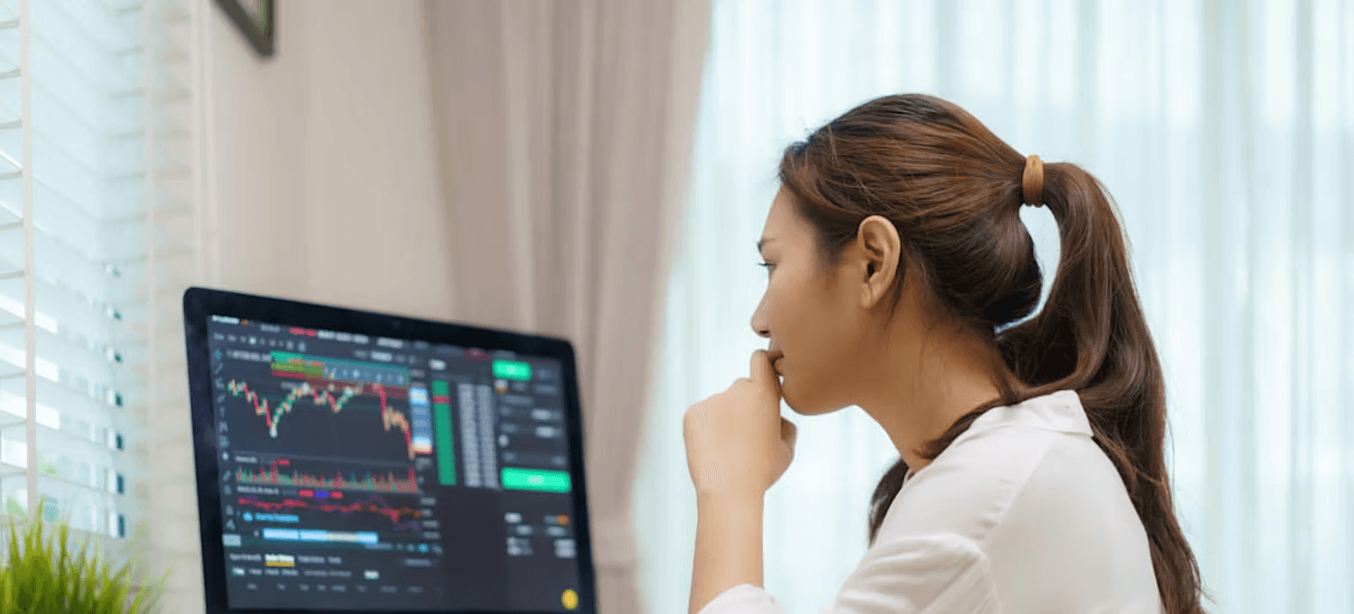 Woman watching live financial trading charts - Why Does Polymarket Have a Waitlist 