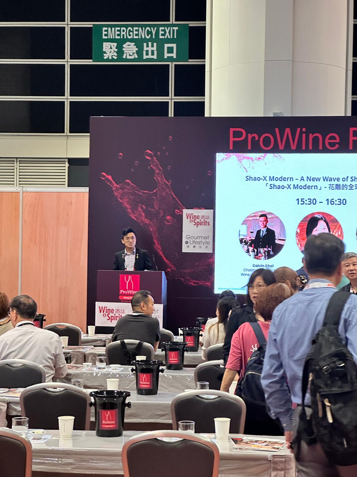 Calvin Choi, Professional WSET-certified sommelier pouring wine at a corporate event, providing expert guidance and tasting notes