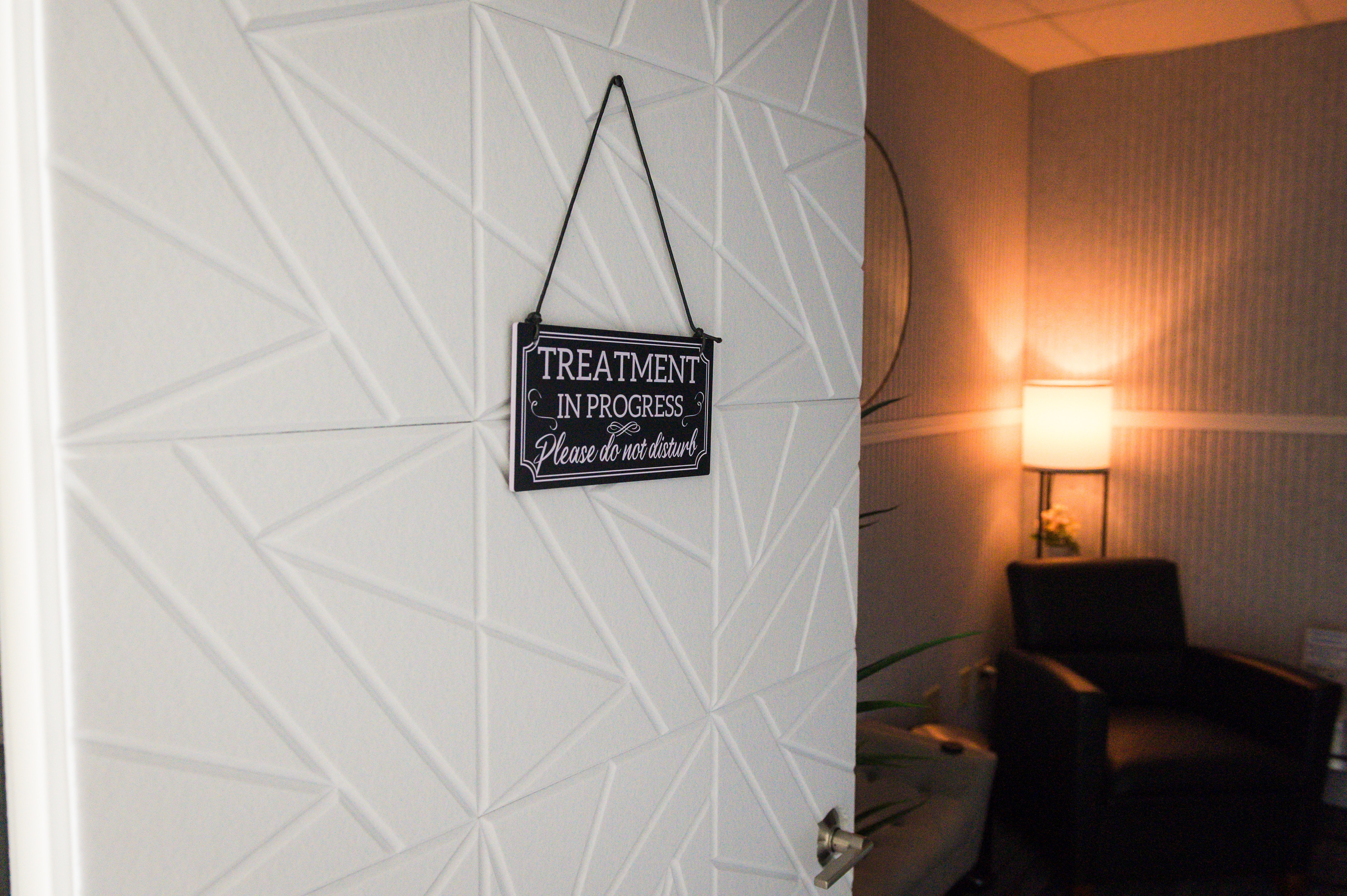 Private massage therapy room at Advantage Physical Therapy featuring a "Treatment in Progress" sign for patient privacy