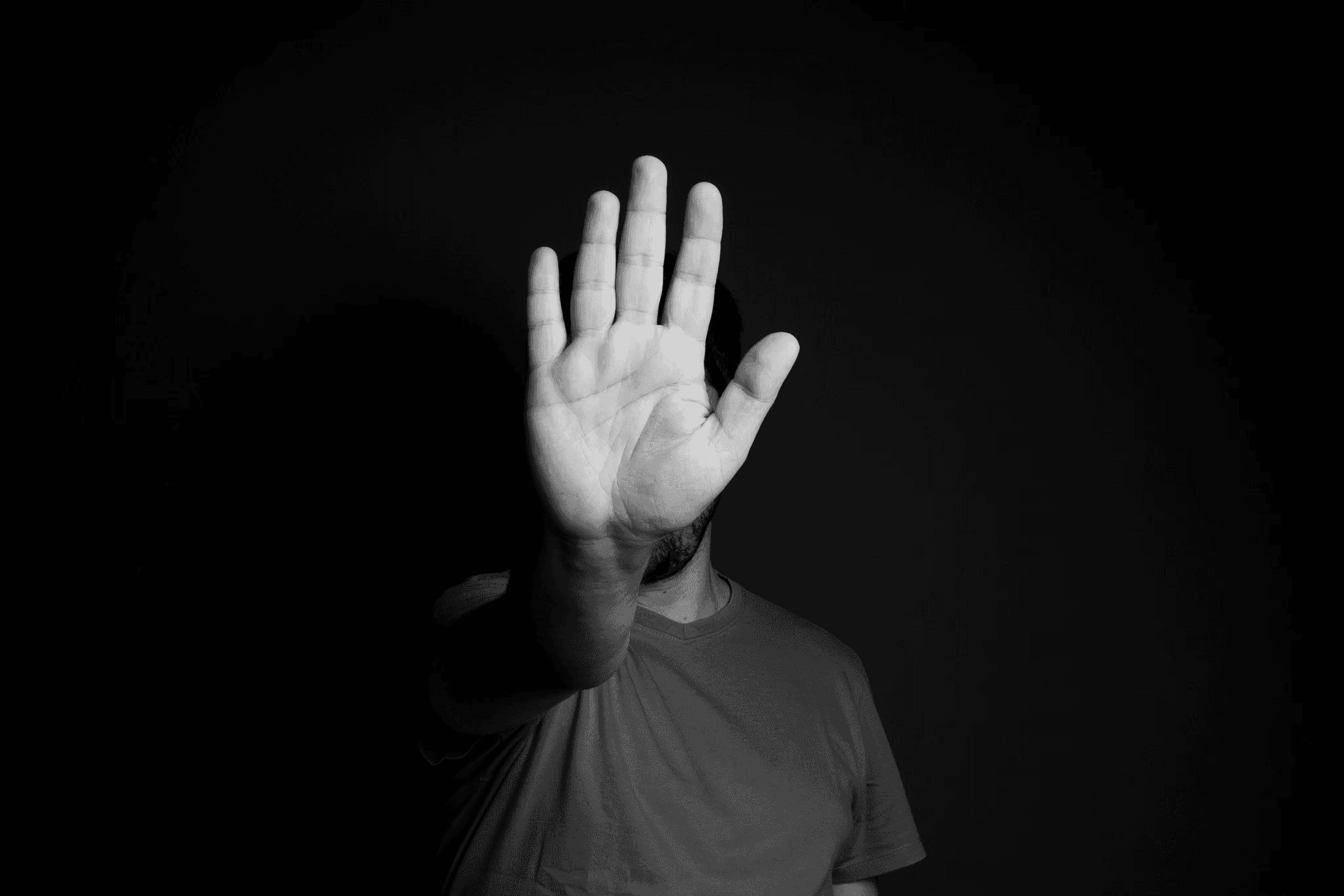 A person extending a palm towards the camera shot