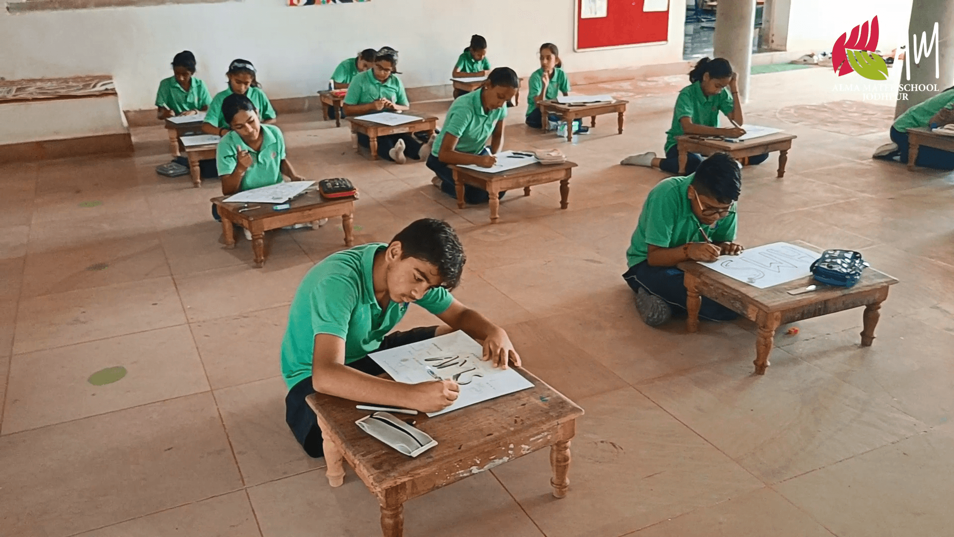 A teacher is showing a globe to a group of students, pointing to different locations as the students watch attentively