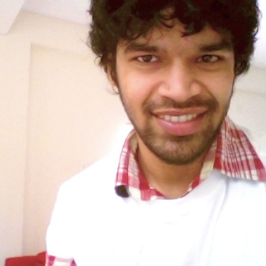 A photo of a man in a white shirt.